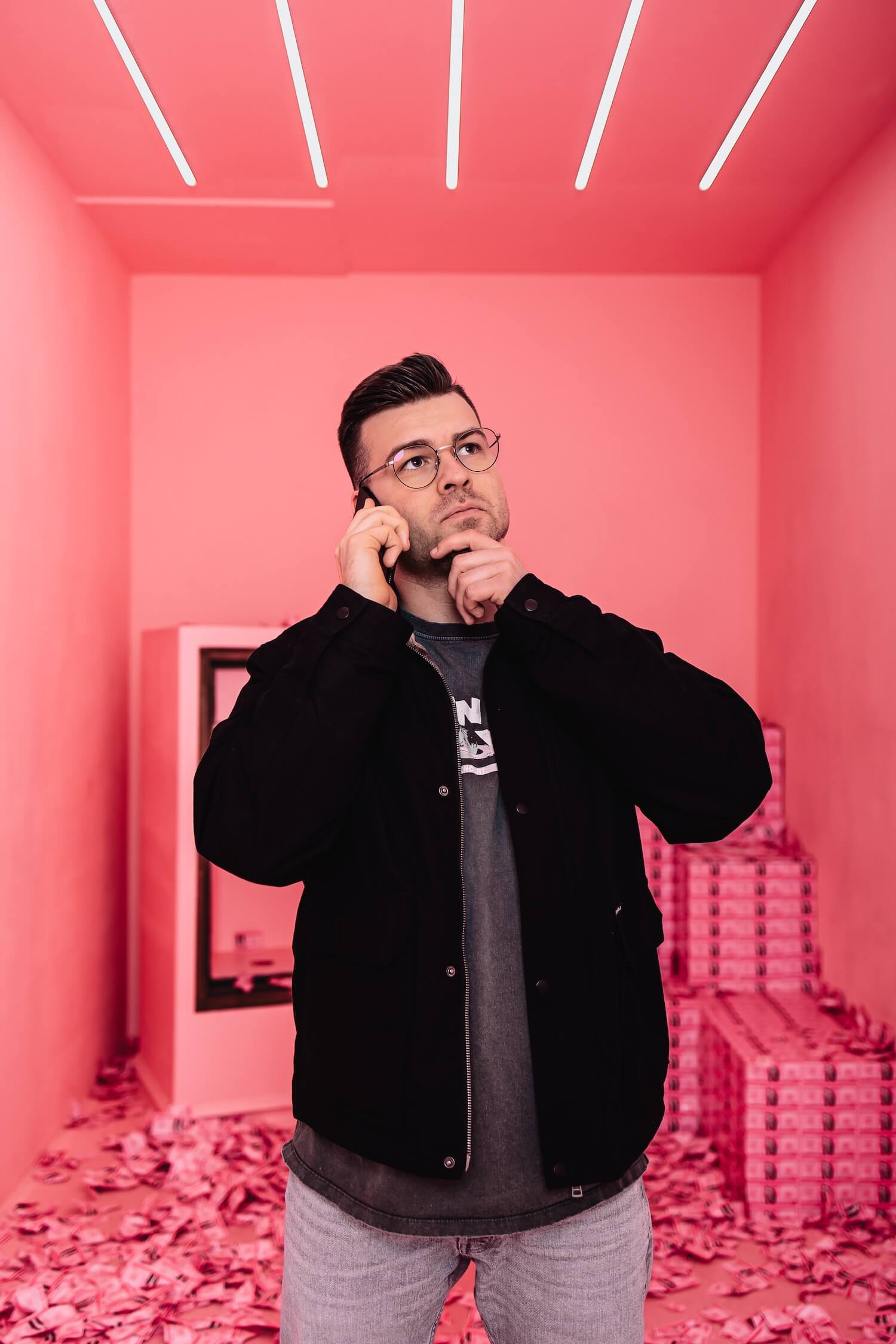 Webentwickler Luca telefoniert in einem pinken Tresor