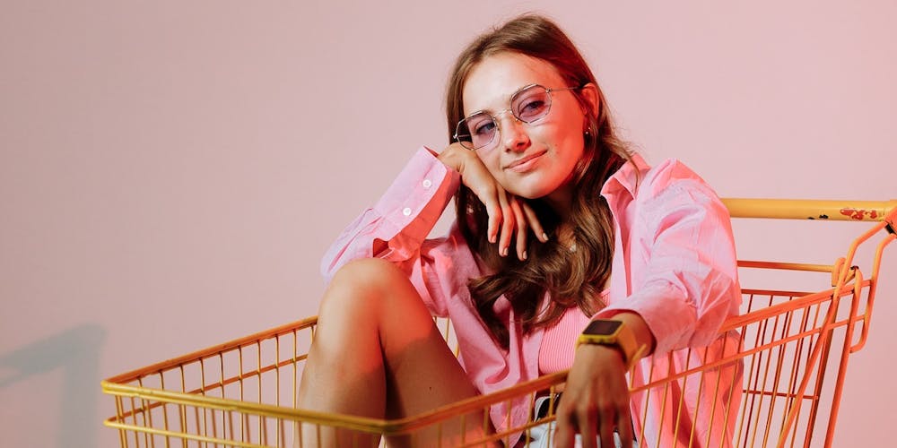 Frau sitzt in Einkaufswagen Frau sitzt in Einkaufswagen