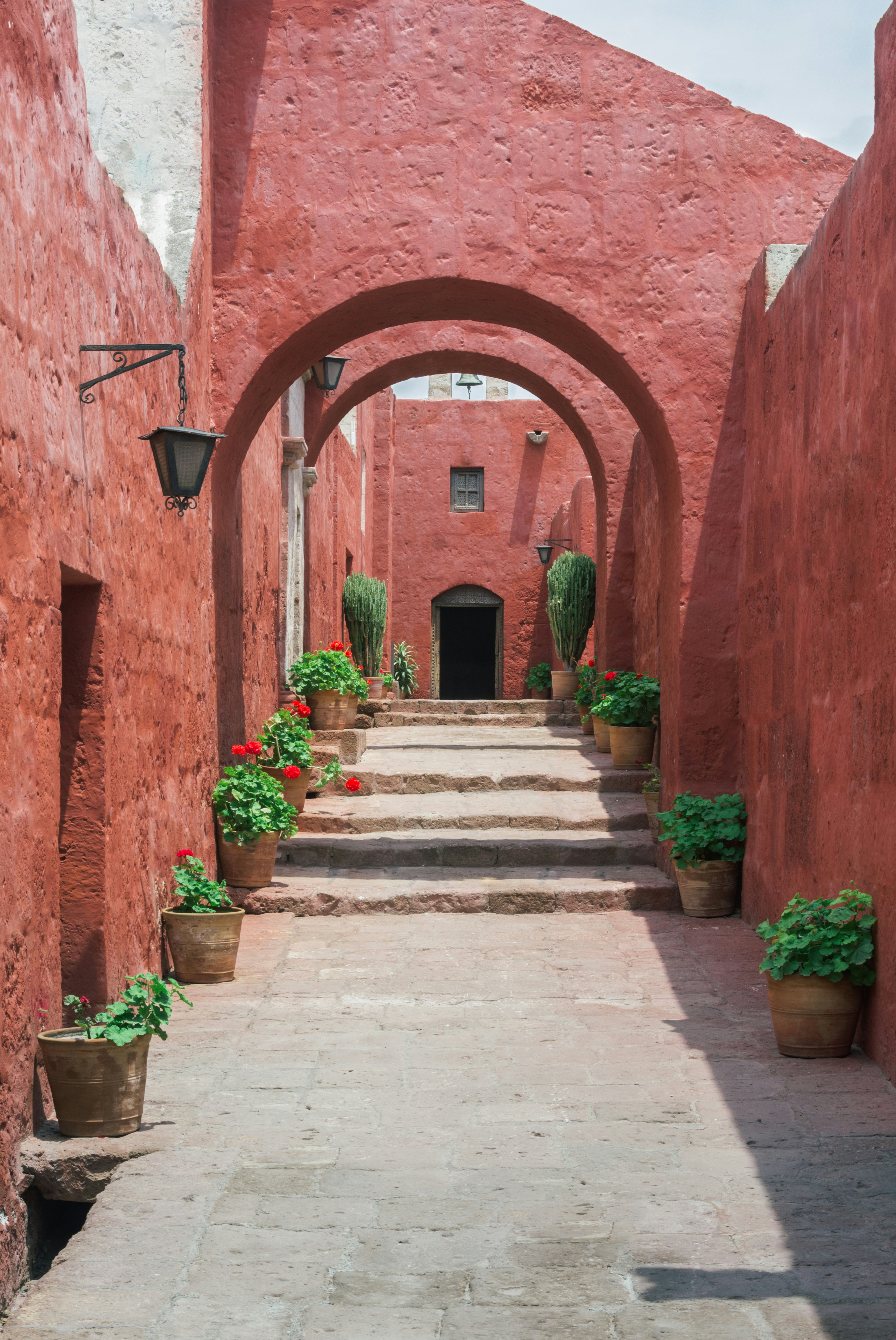 Red arched corridor with geraniums, Santa Catalina Monastery Arequipa