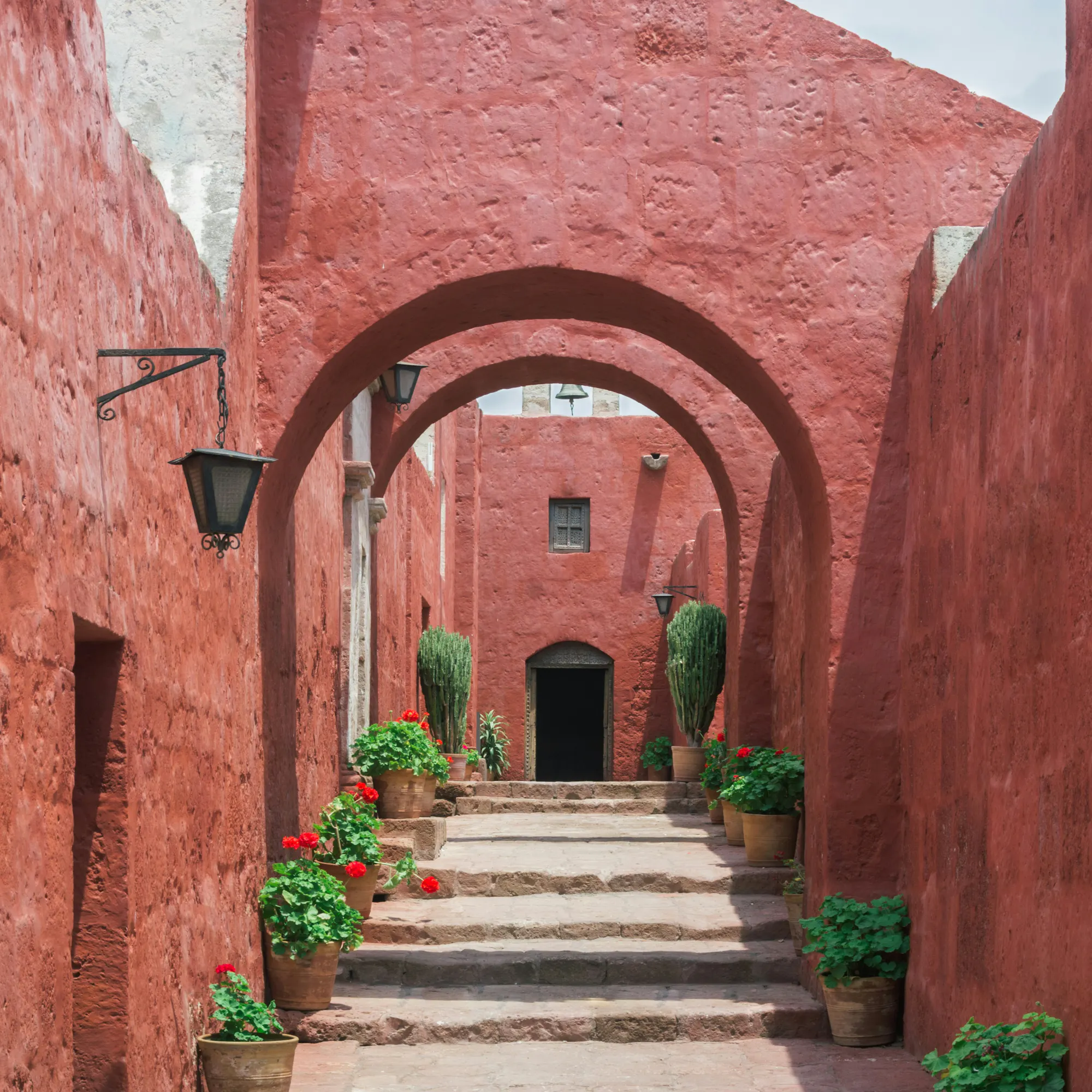 Red arched corridor with geraniums, Santa Catalina Monastery Arequipa