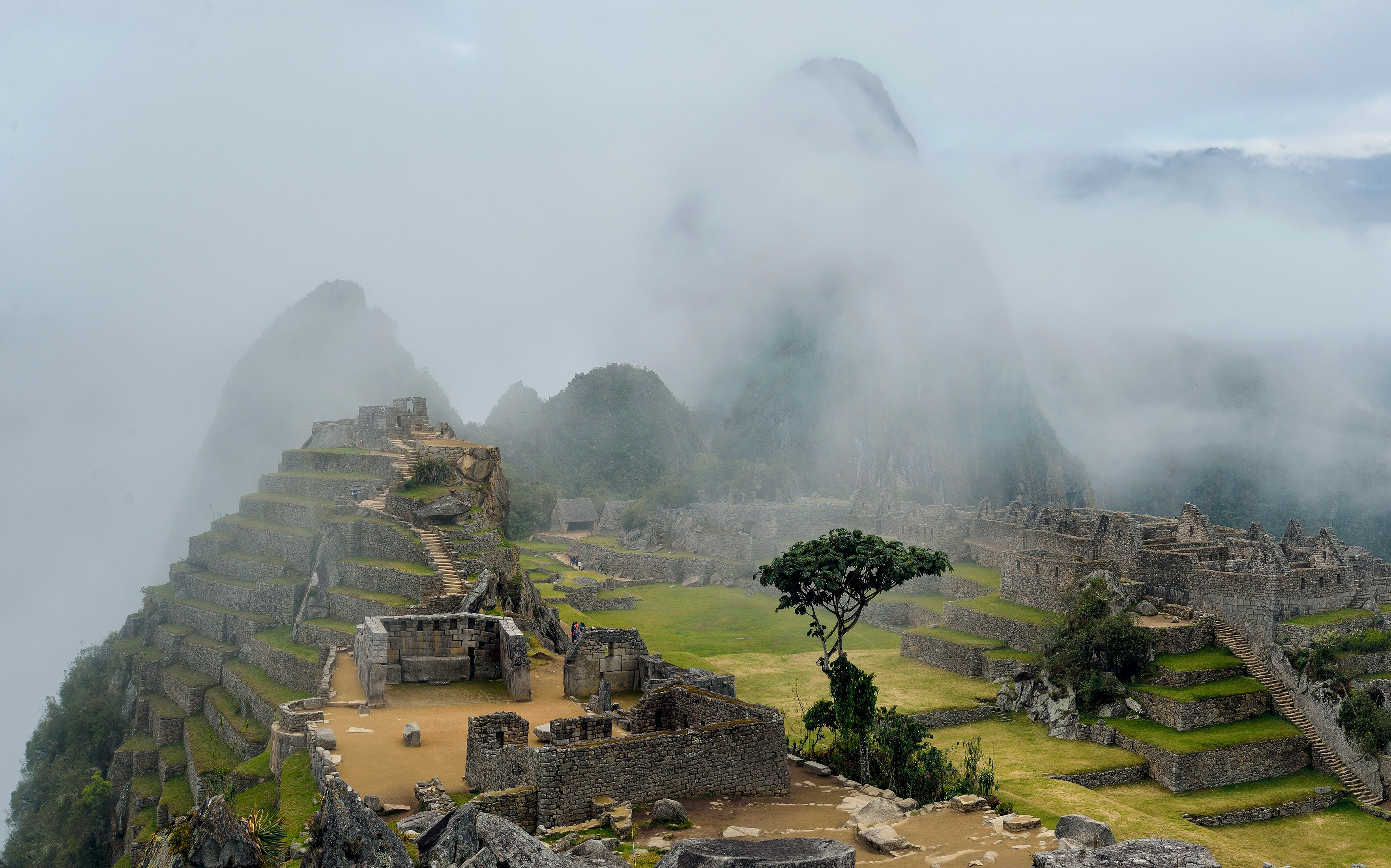 Misty clouds rolling over ancient Inca ruins, Machu Picchu Peru