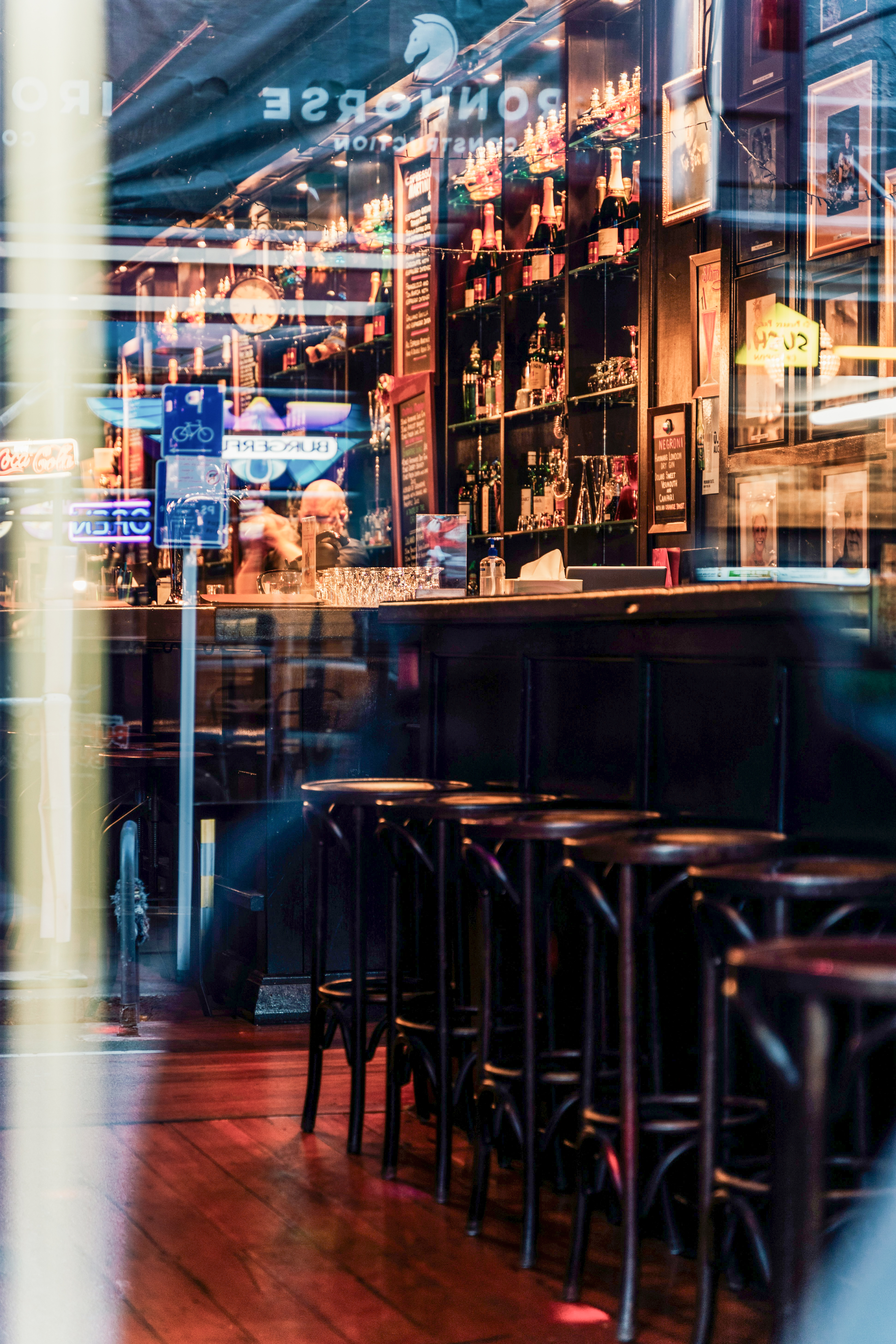 Warm cocktail bar interior glimpsed through window, Wellington New Zealand