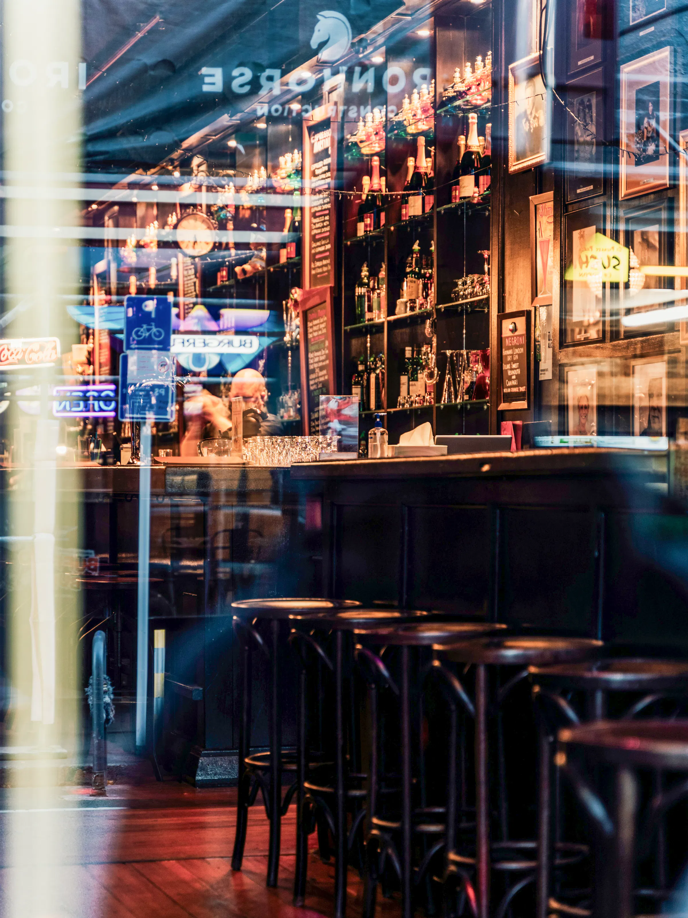 Warm cocktail bar interior glimpsed through window, Wellington New Zealand