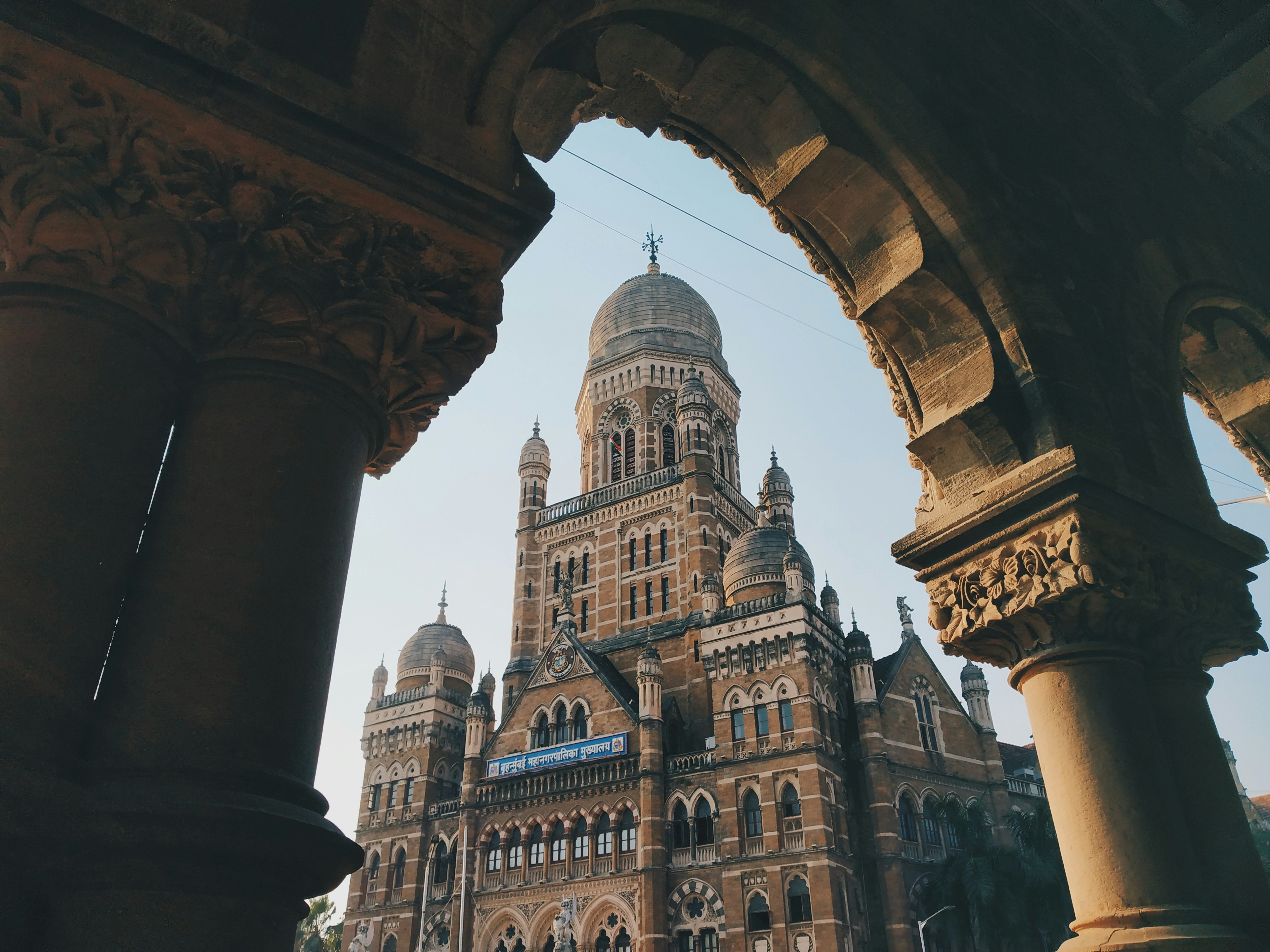 Victorian Gothic BMC headquarters framed by stone arch, Mumbai