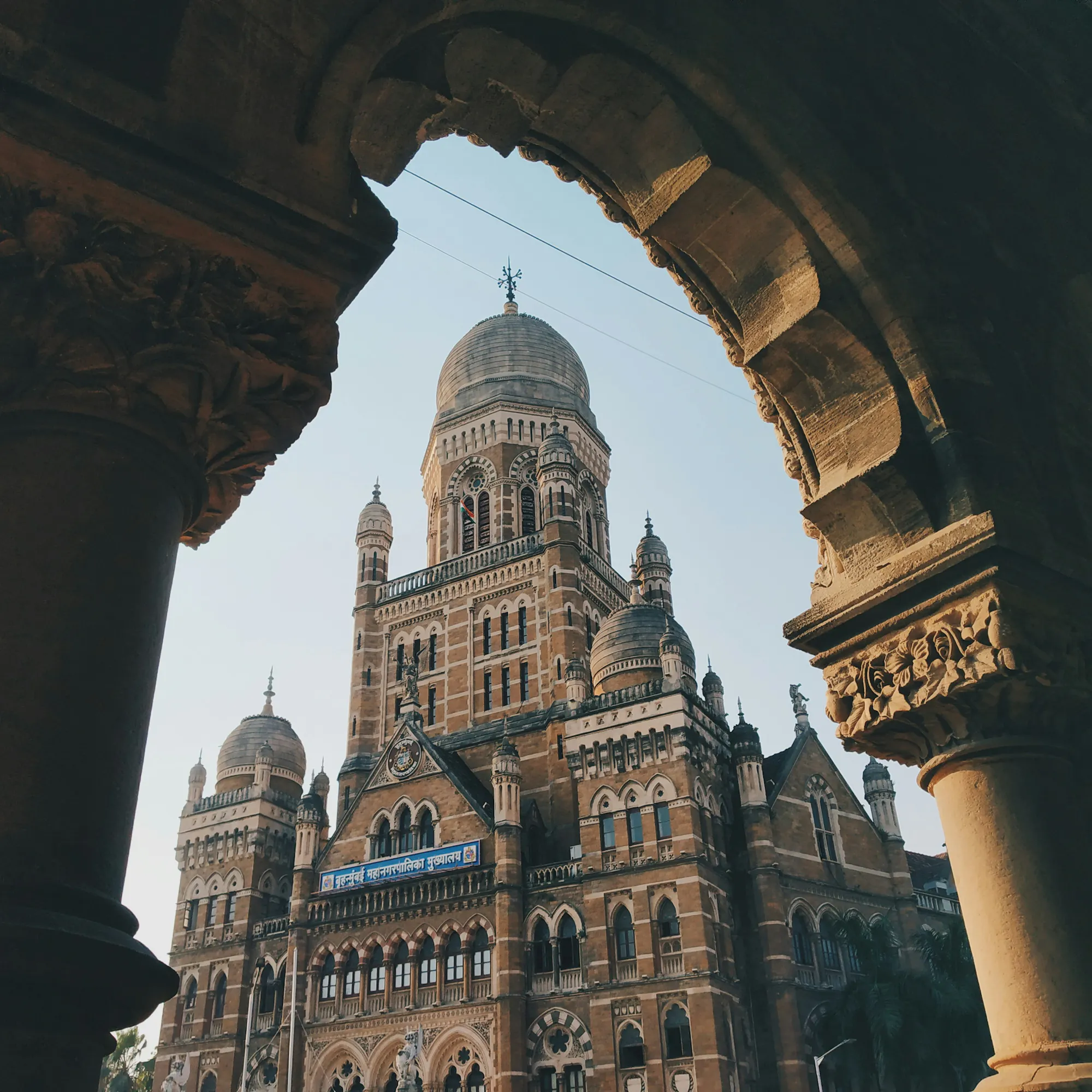 Victorian Gothic BMC headquarters framed by stone arch, Mumbai