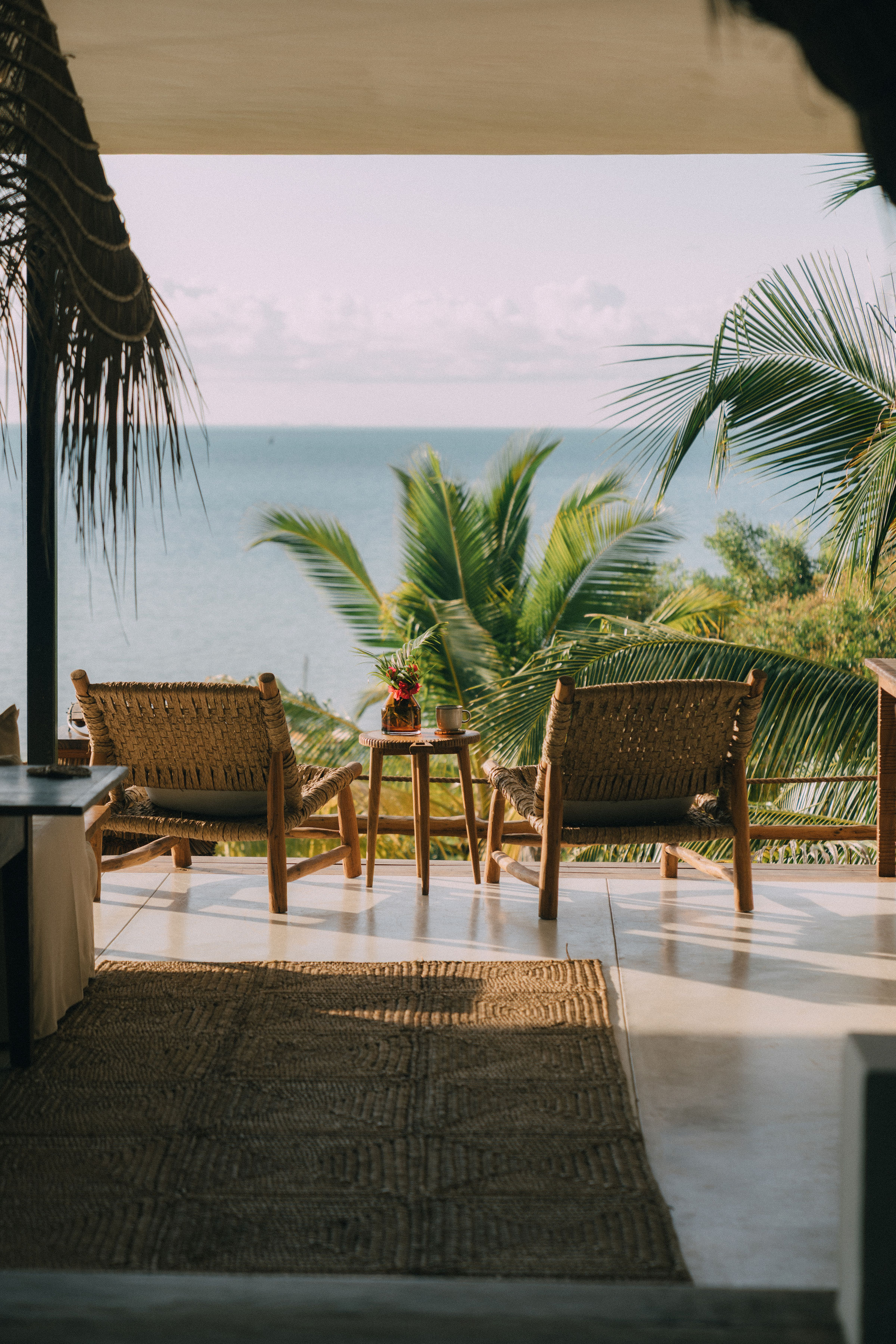 Woven rattan terrace chairs overlooking Indian Ocean Mozambique beach lodge