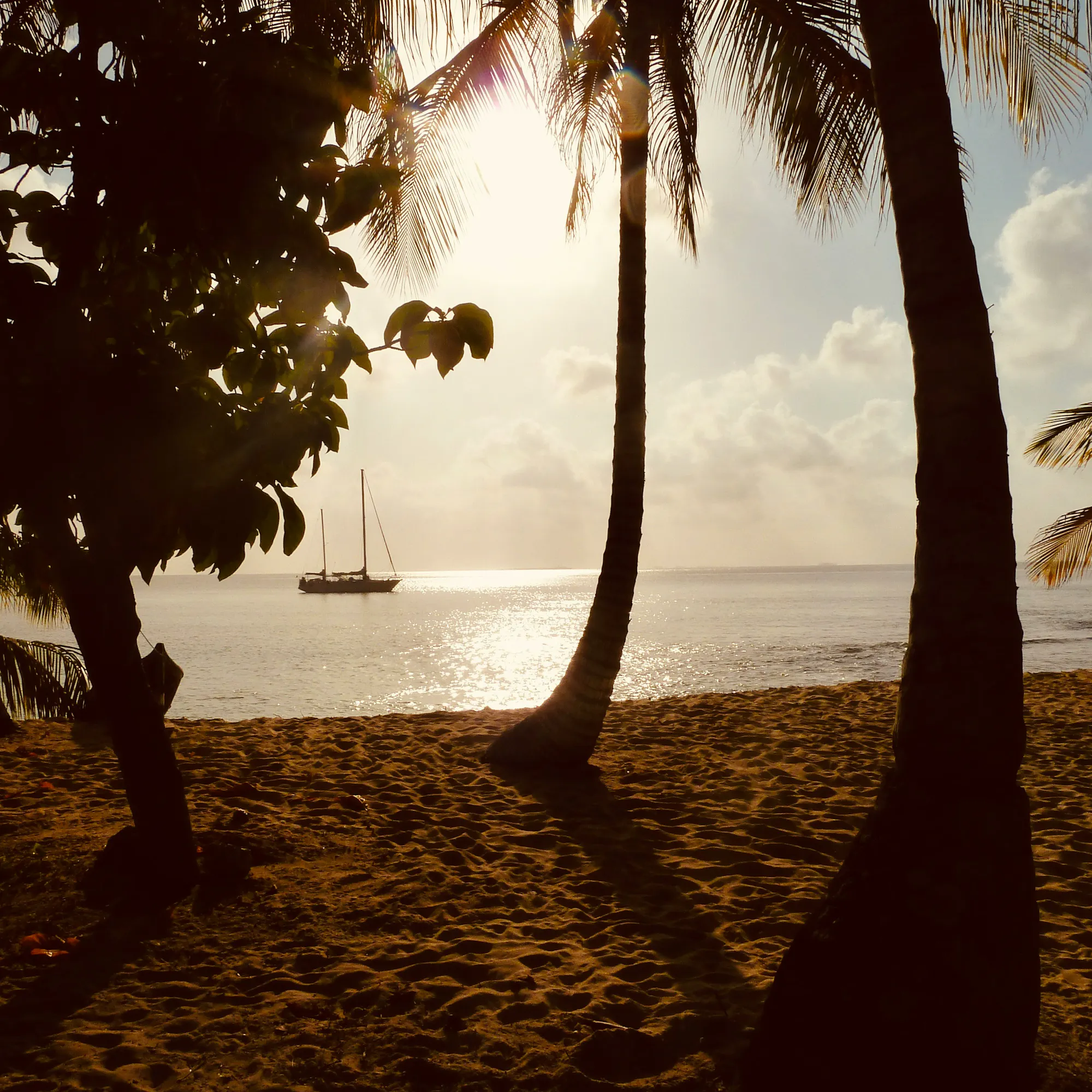 beach sunset with boat in the background