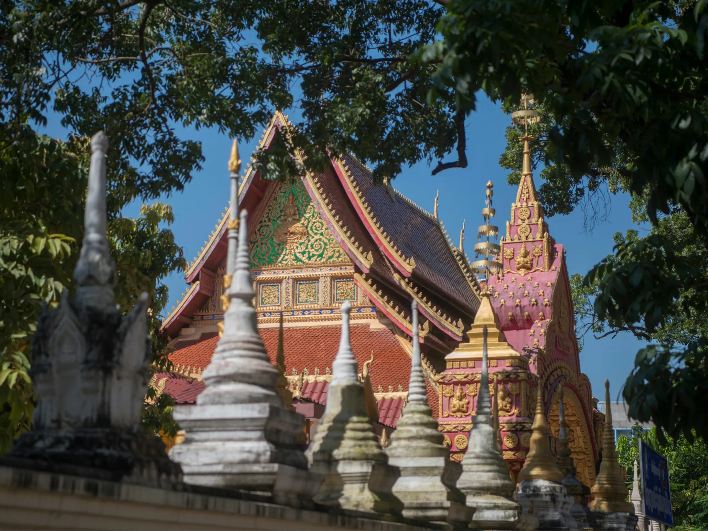 Ornate Buddhist temple roof and stupas at a Vientiane wat, Laos