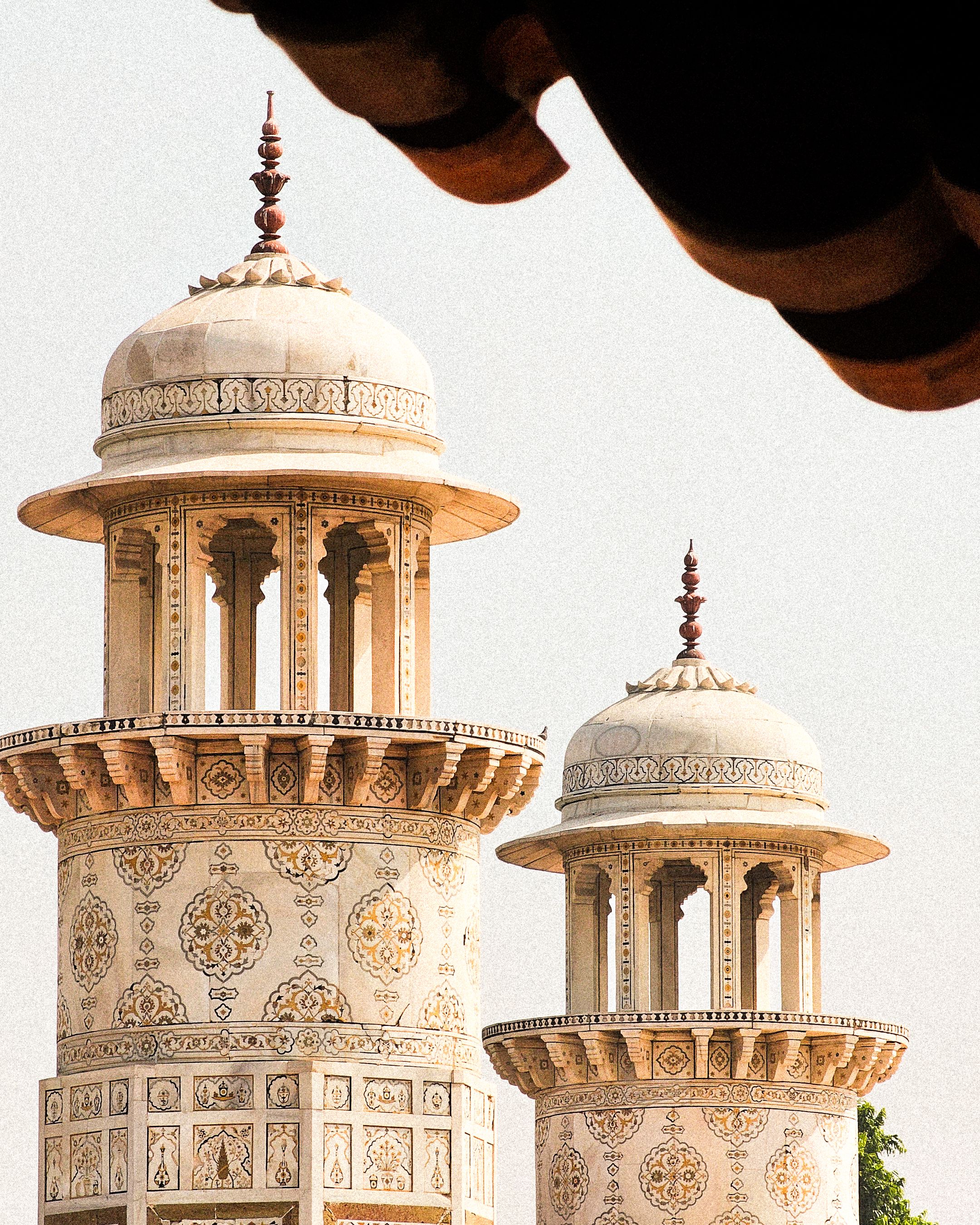 Close-up of ornate marble minaret domes with intricate inlay patterns at the Taj Mahal, Agra