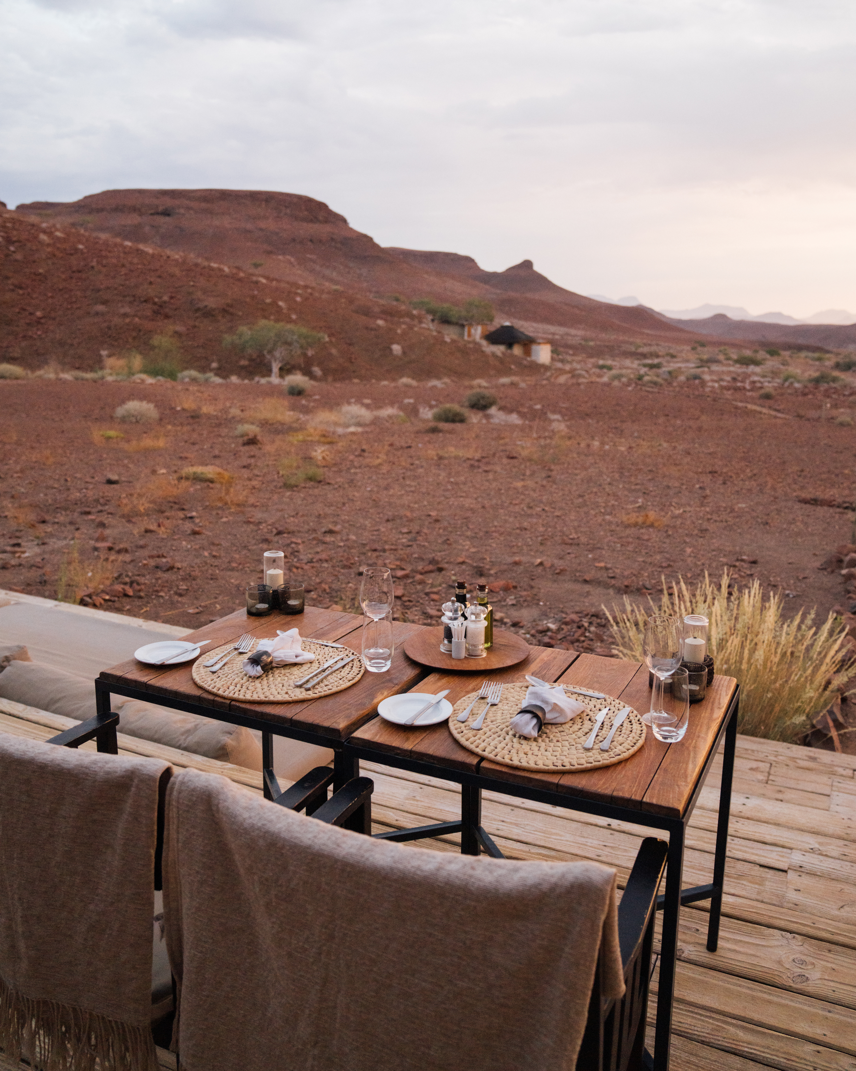 Outdoor dining table set for two overlooking the desert landscape at Damaraland Camp, Namibia