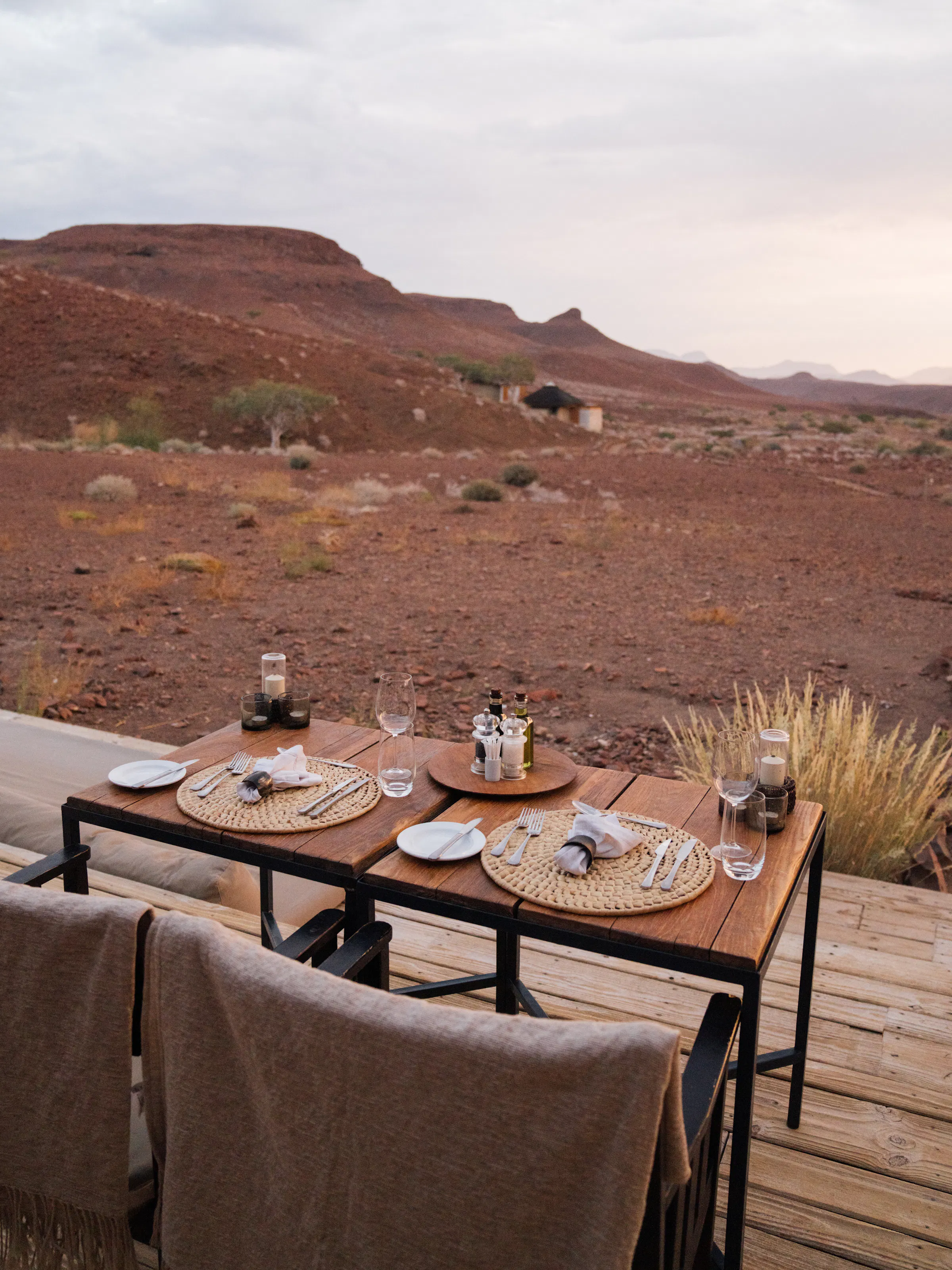 Outdoor dining table set for two overlooking the desert landscape at Damaraland Camp, Namibia