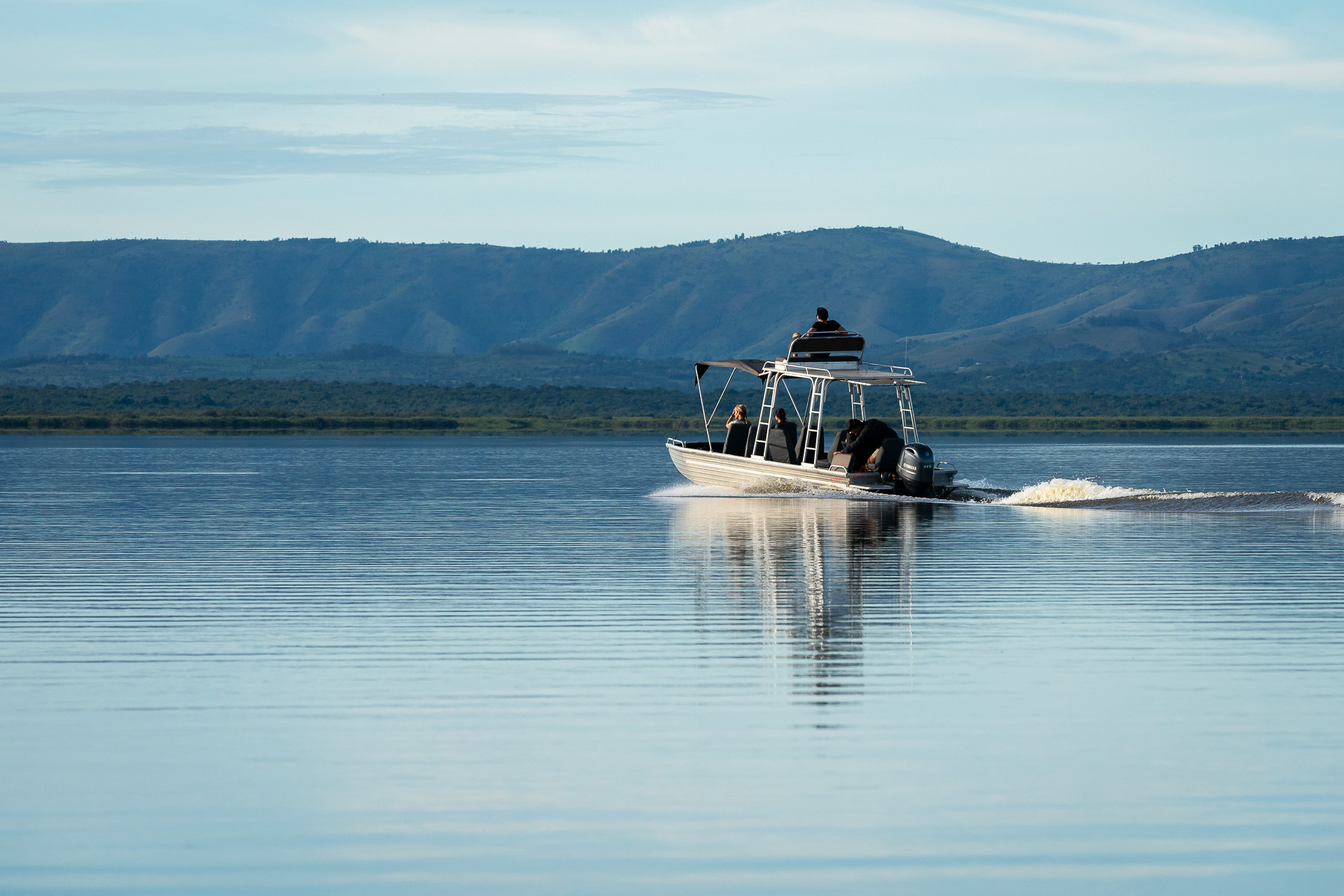 Safari boat cruising on a lake in Akagera National Park, Rwanda
