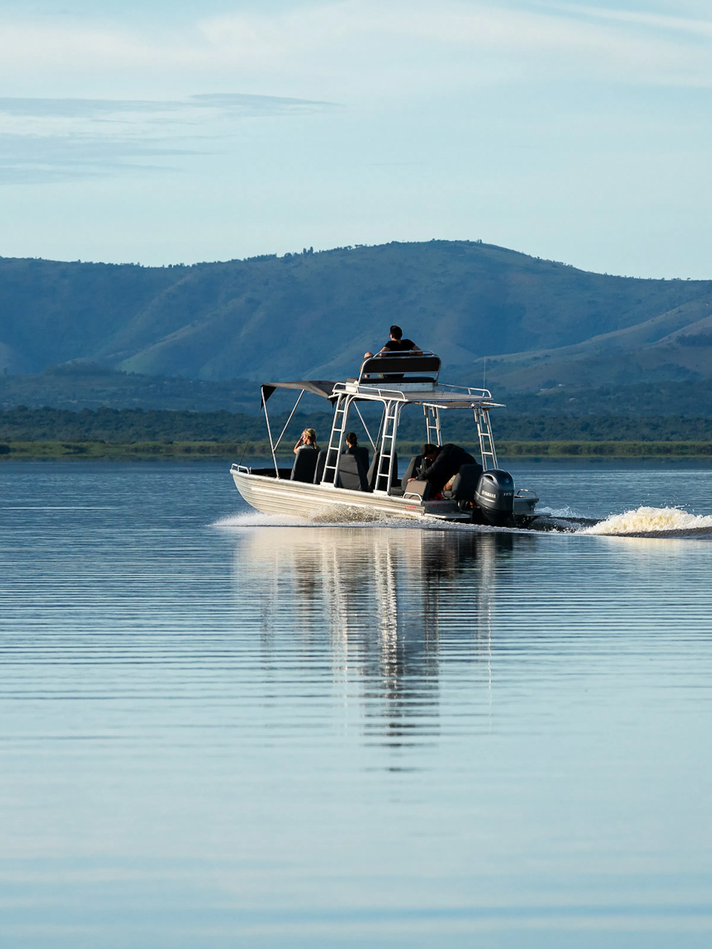 Safari boat cruising on a lake in Akagera National Park, Rwanda