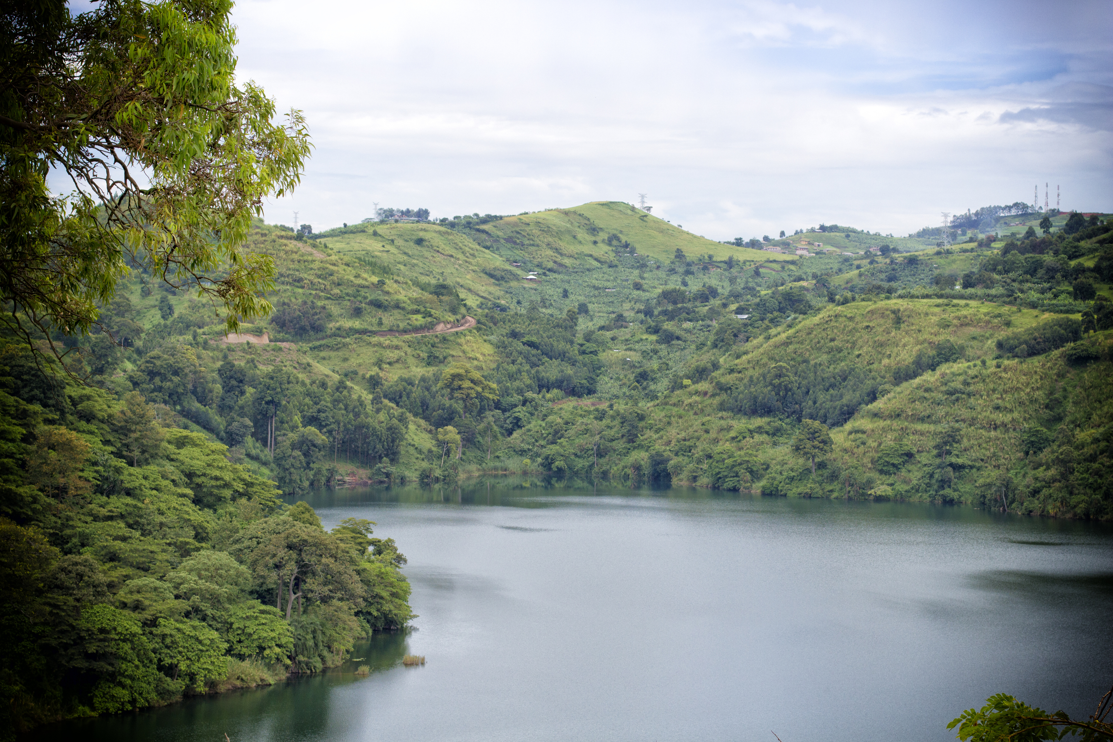 Crater lake surrounded by green hills near Kibale National Park, Uganda