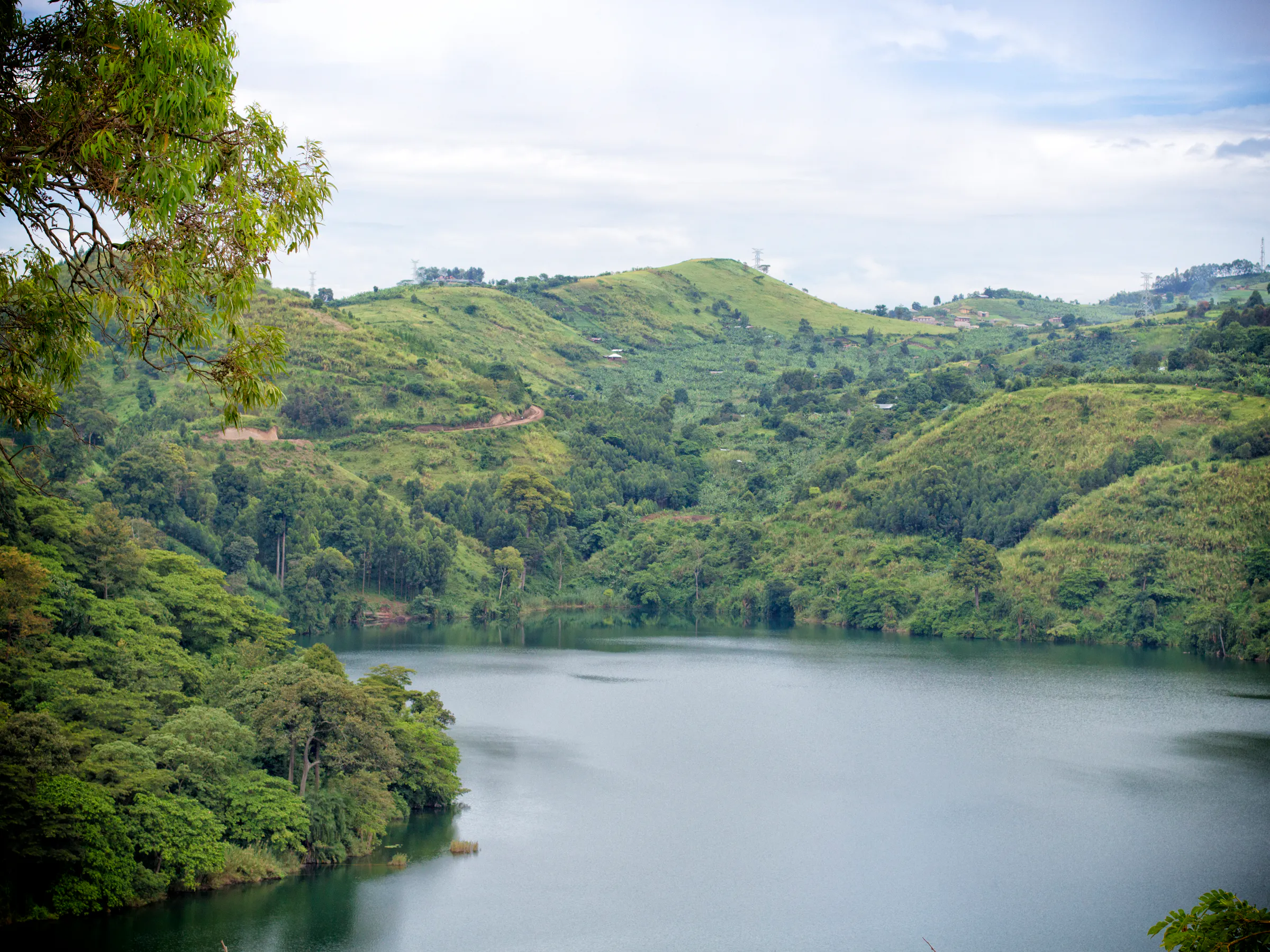 Crater lake surrounded by green hills near Kibale National Park, Uganda