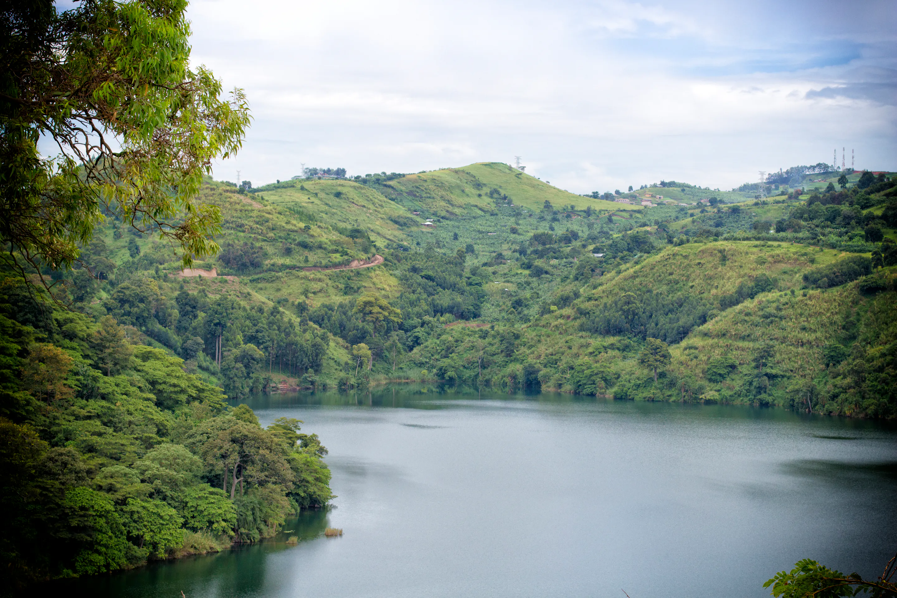 Crater lake surrounded by green hills near Kibale National Park, Uganda
