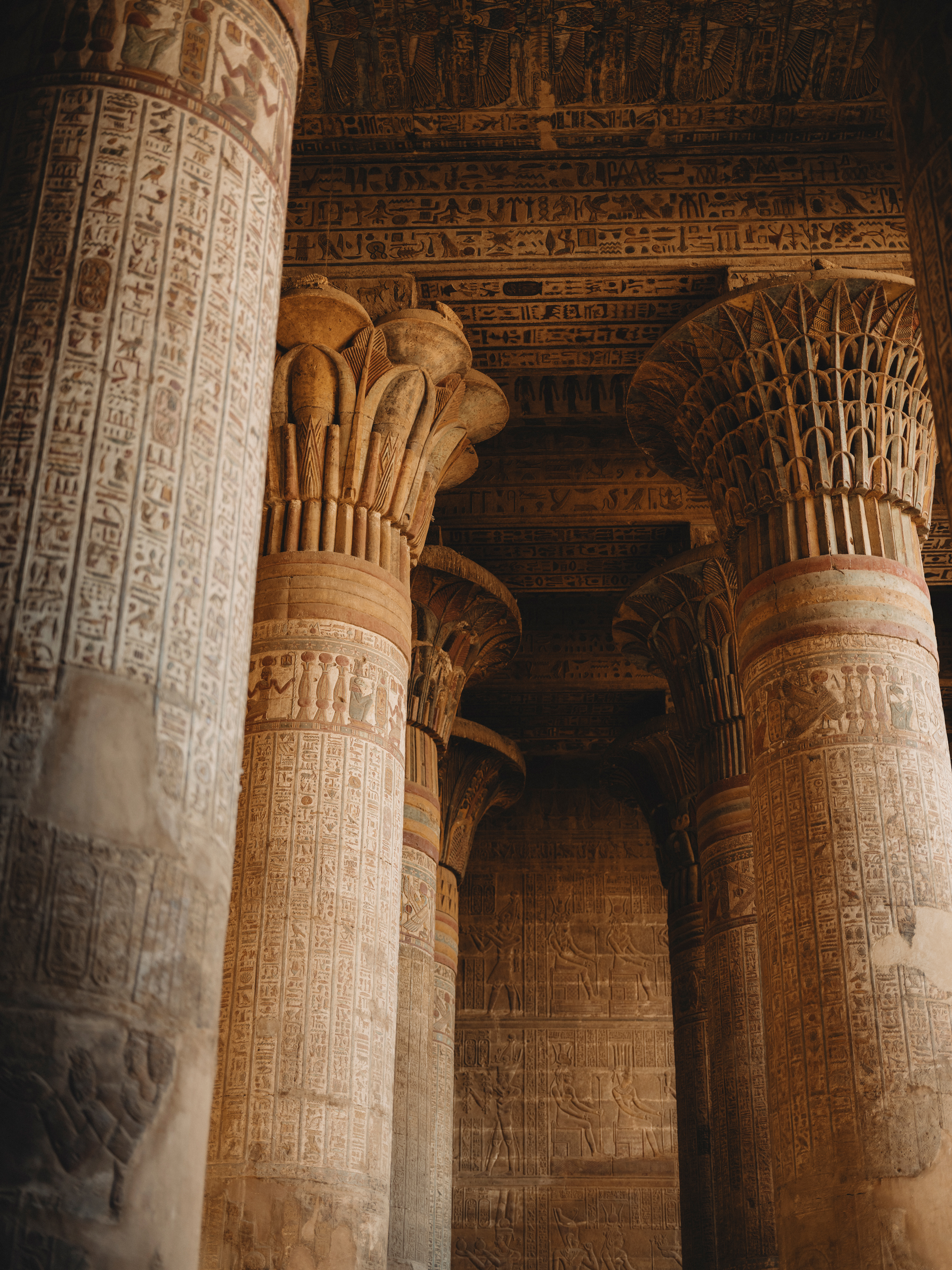 Hieroglyph-carved columns and painted ceiling, Dendera Temple Egypt