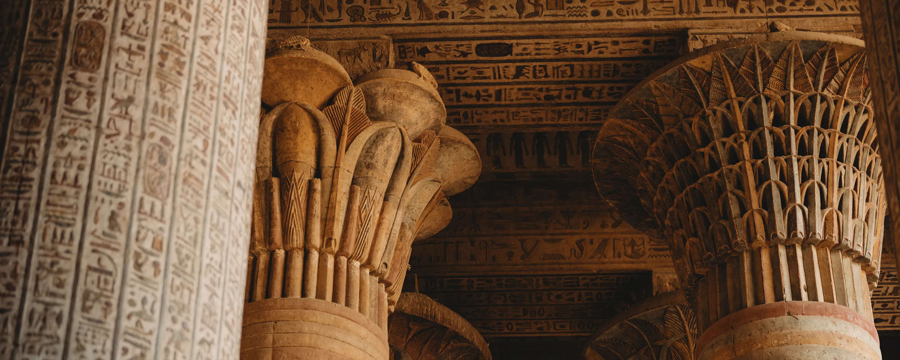 Hieroglyph-carved columns and painted ceiling, Dendera Temple Egypt