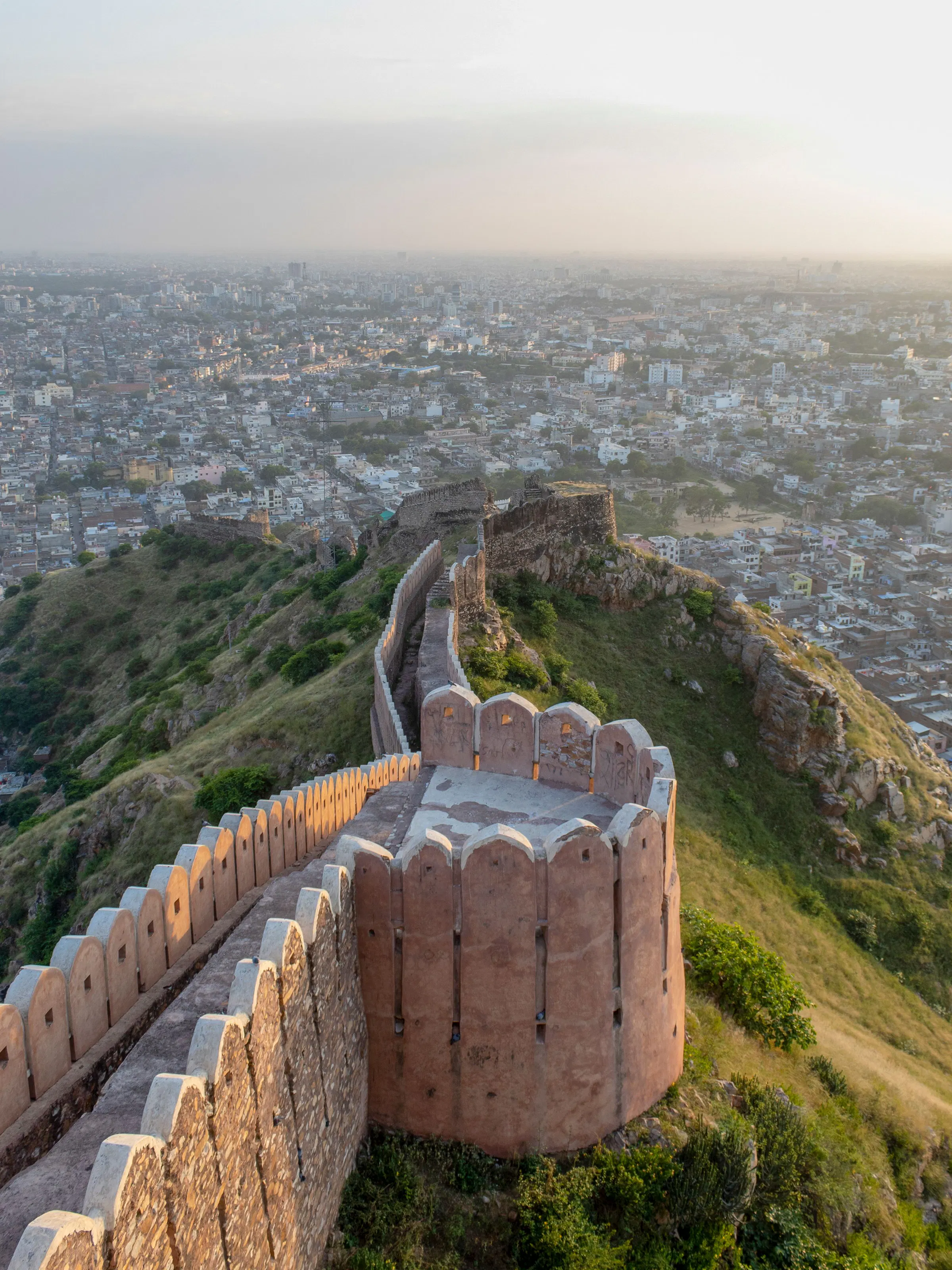 Ancient fort walls overlooking Jaipur city at sunset, Rajasthan