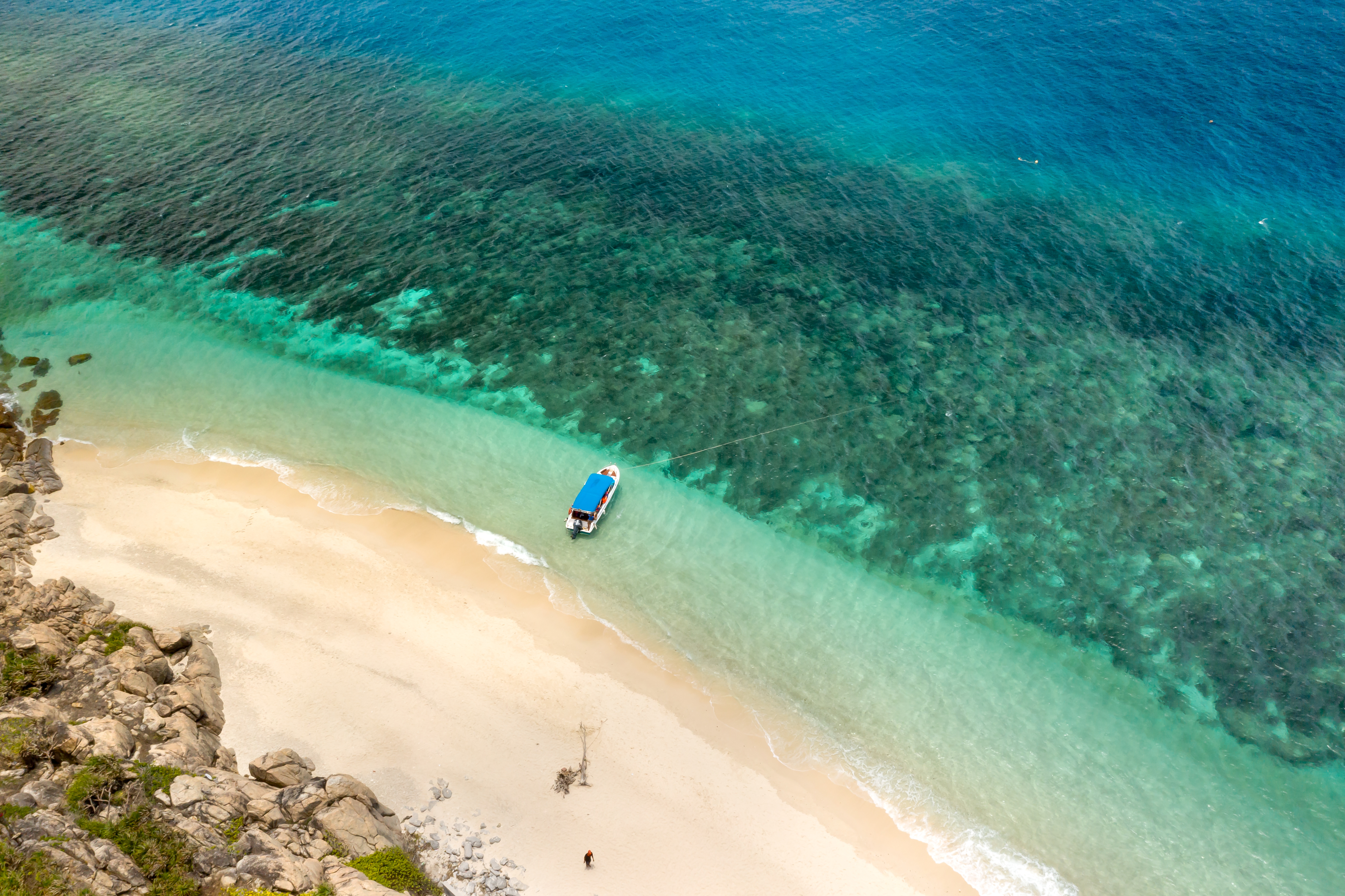 Aerial view of boat on pristine turquoise beach, Con Dao Islands Vietnam