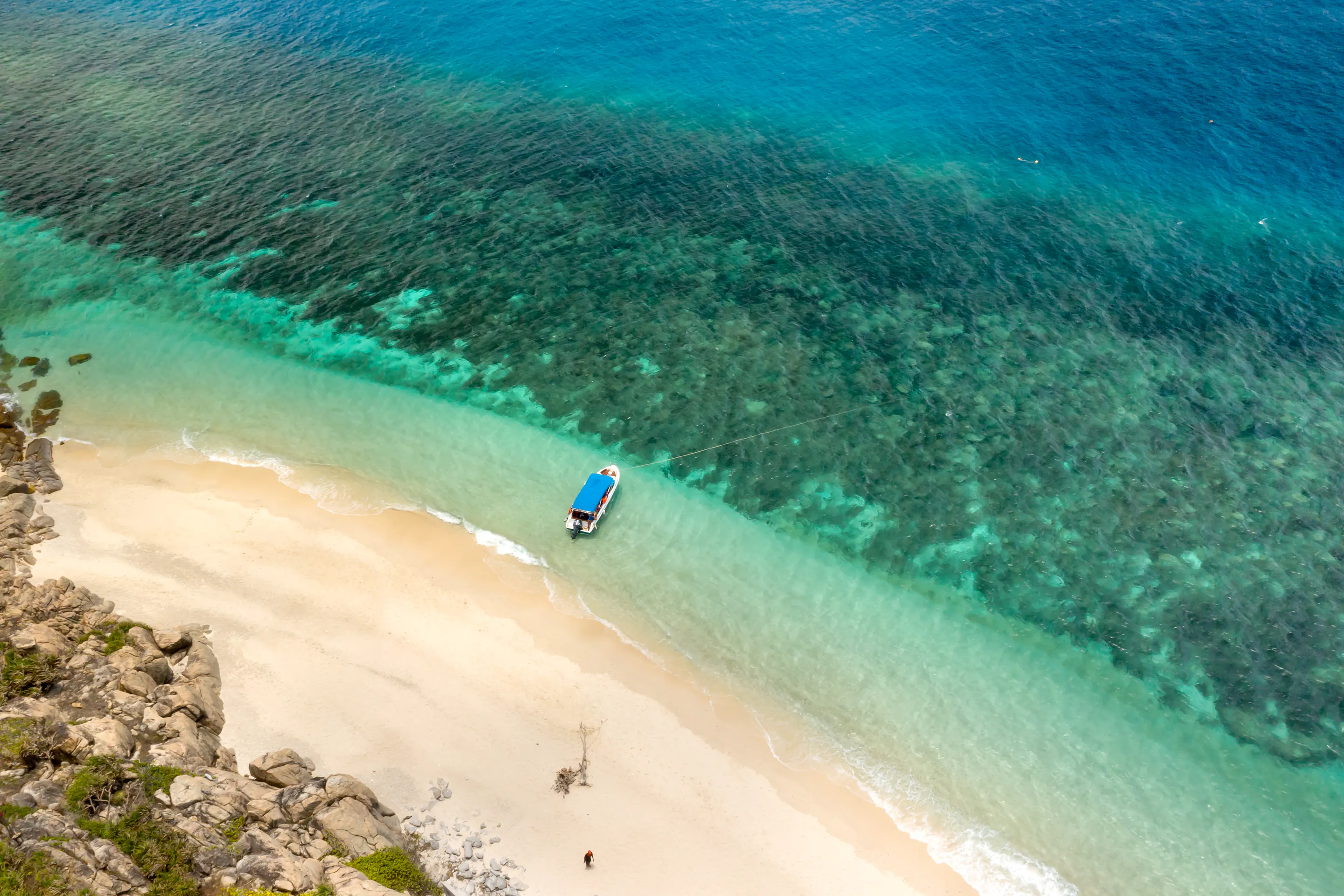 Aerial view of boat on pristine turquoise beach, Con Dao Islands Vietnam