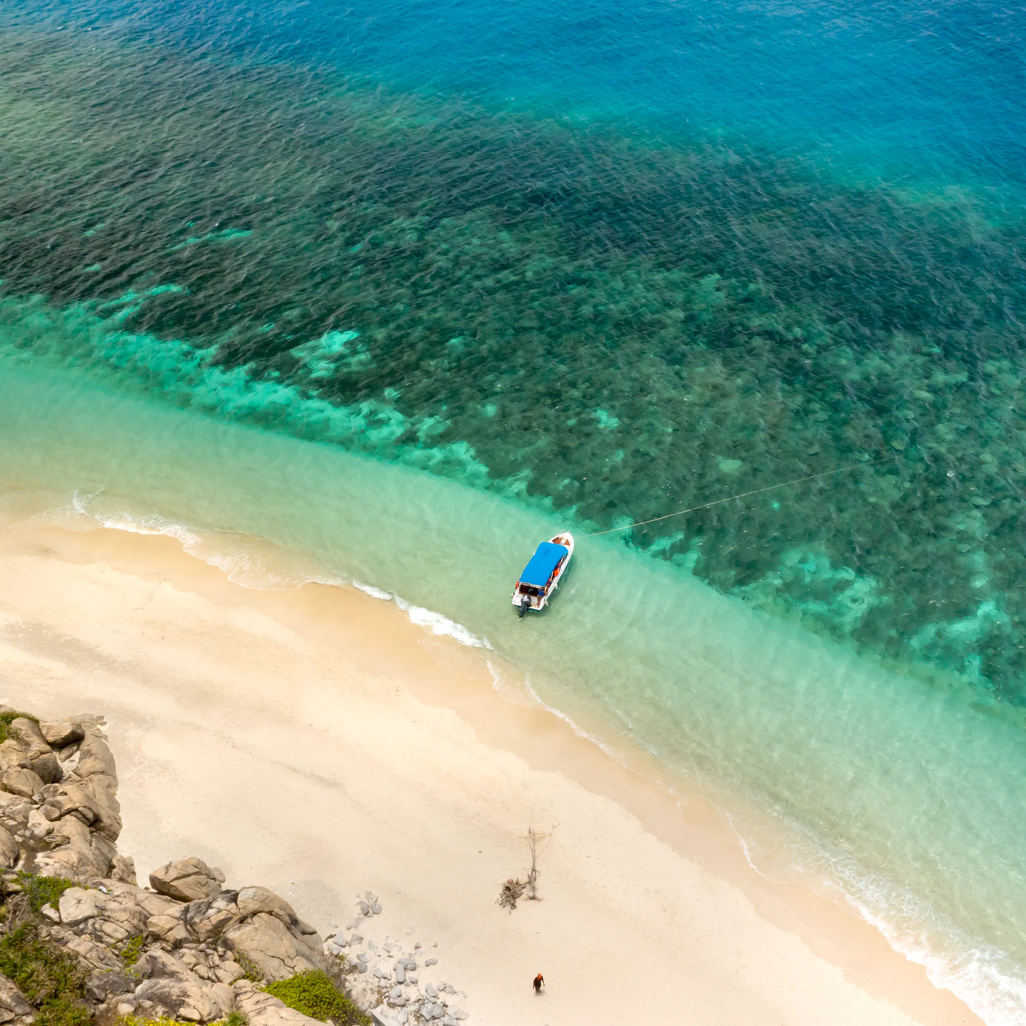 Aerial view of boat on pristine turquoise beach, Con Dao Islands Vietnam