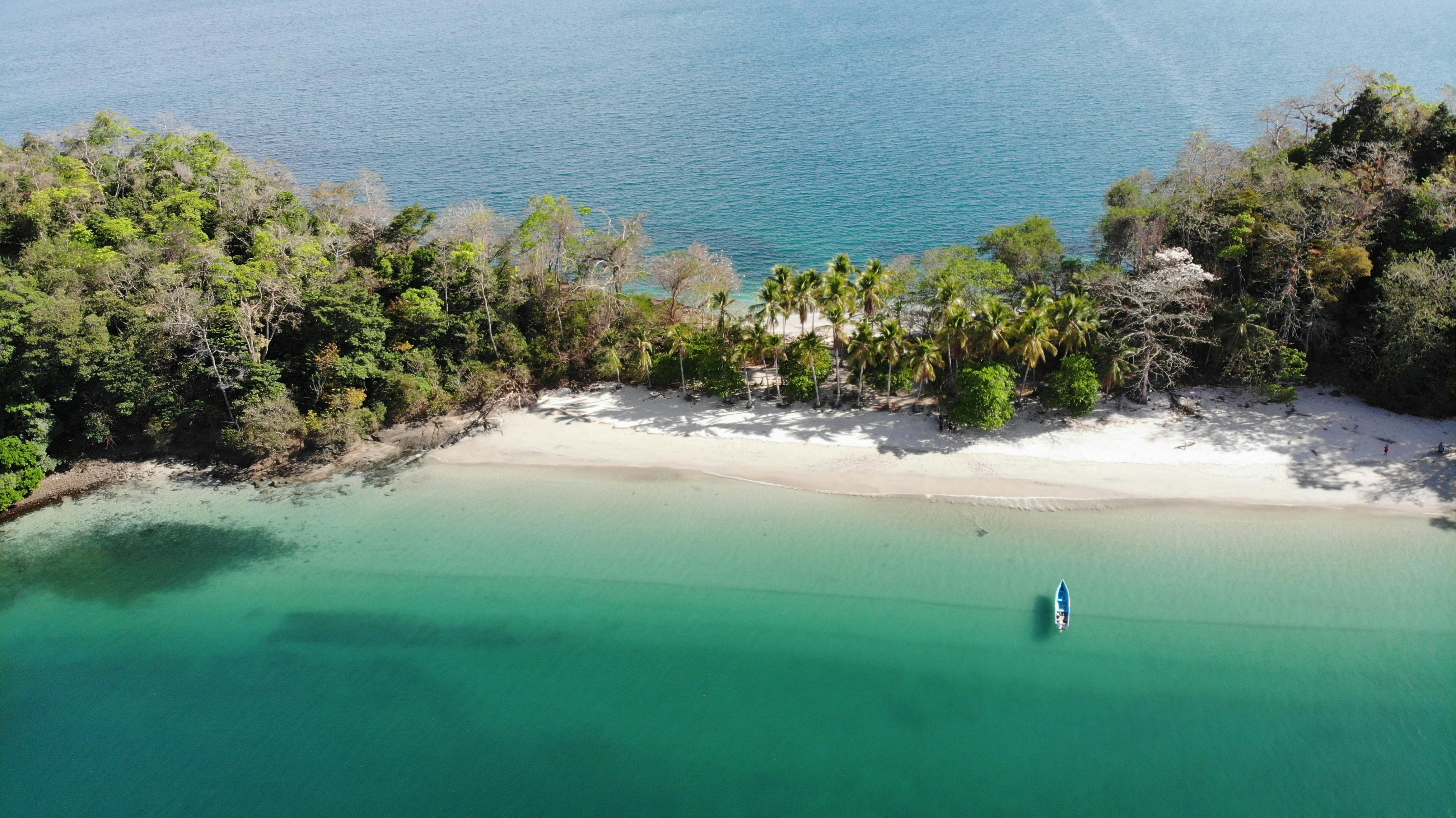 boat by beach on tropical island