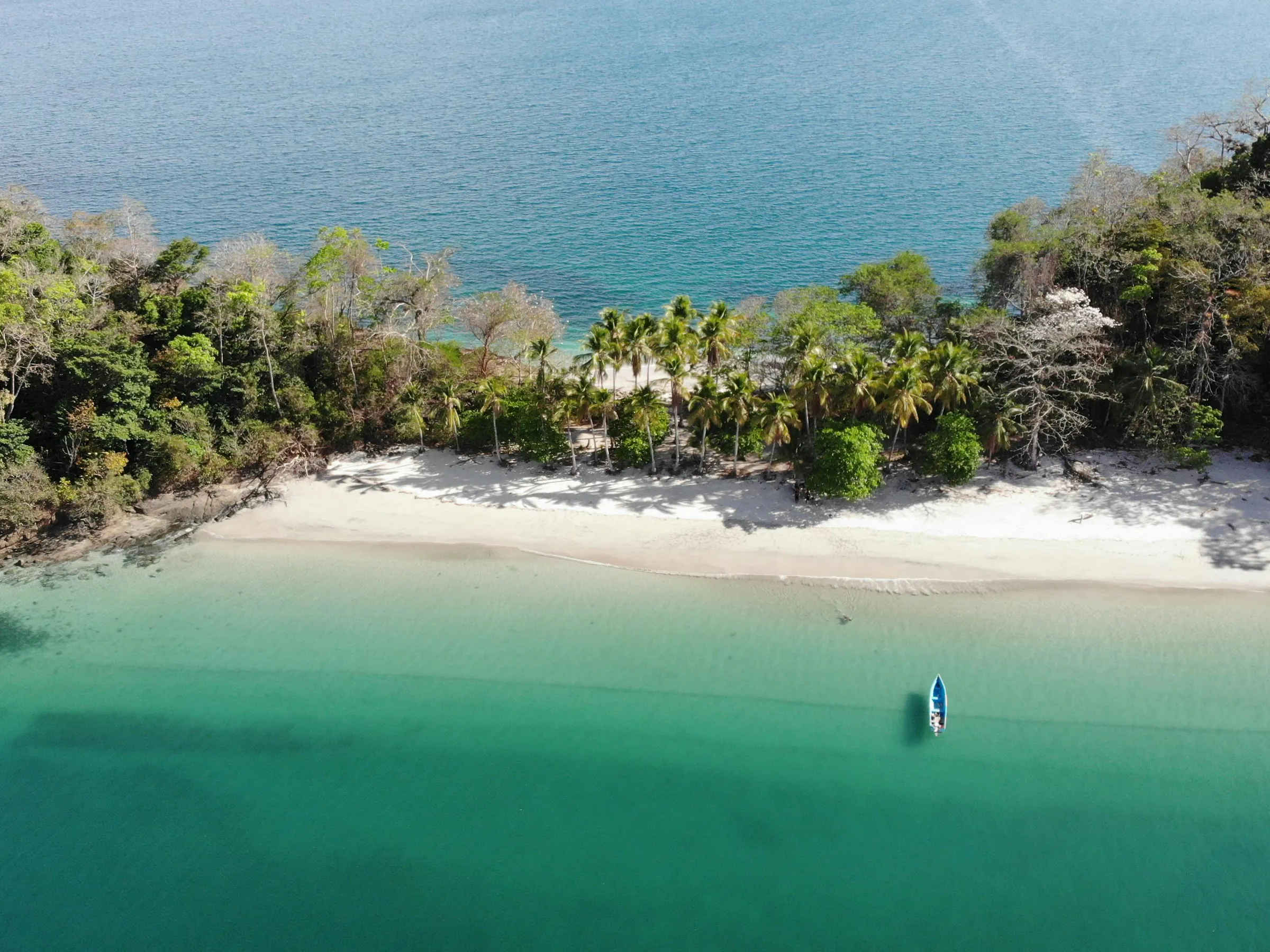 boat by beach on tropical island