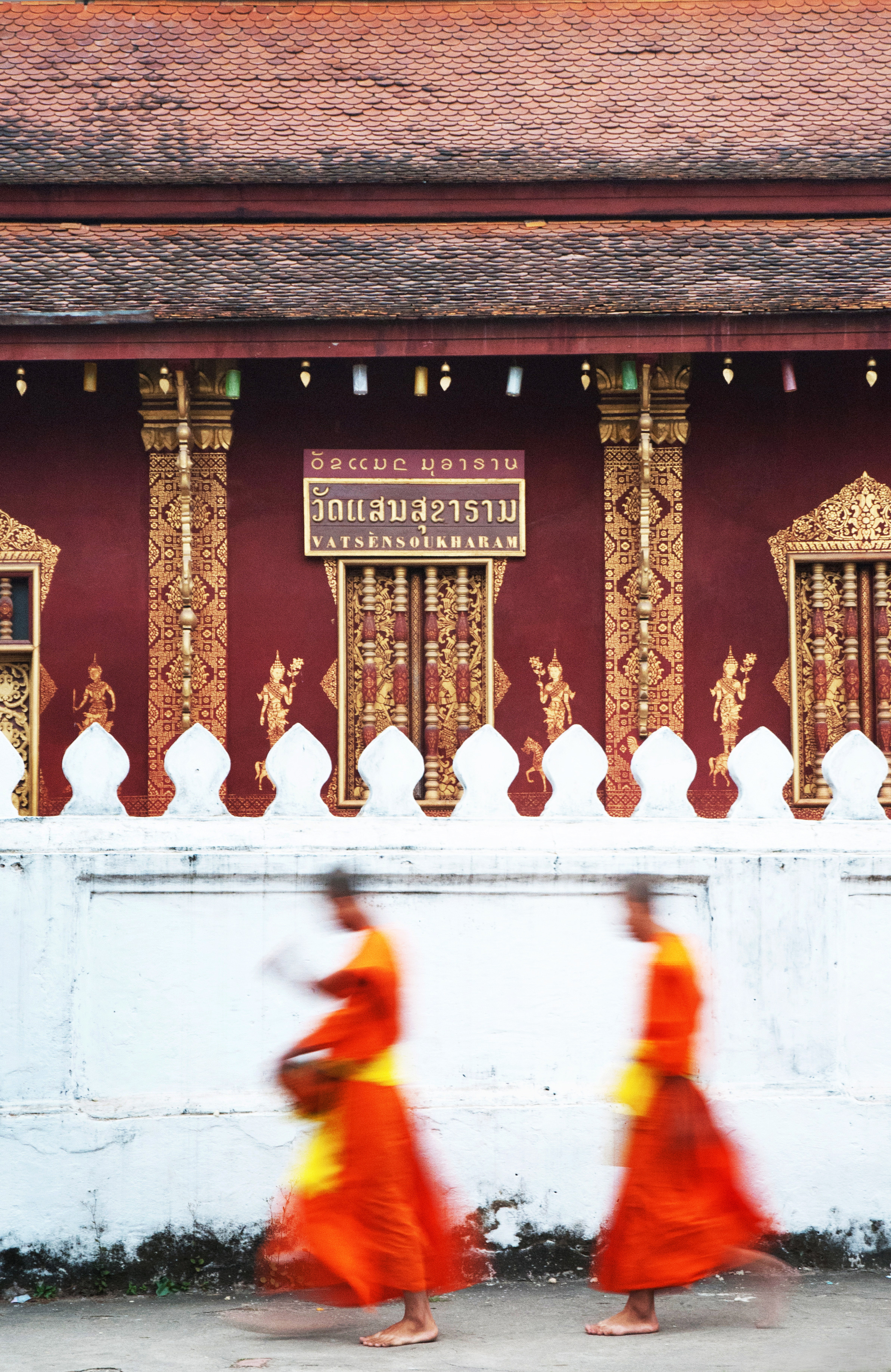 Buddhist monks in orange robes, Luang Prabang Laos temple