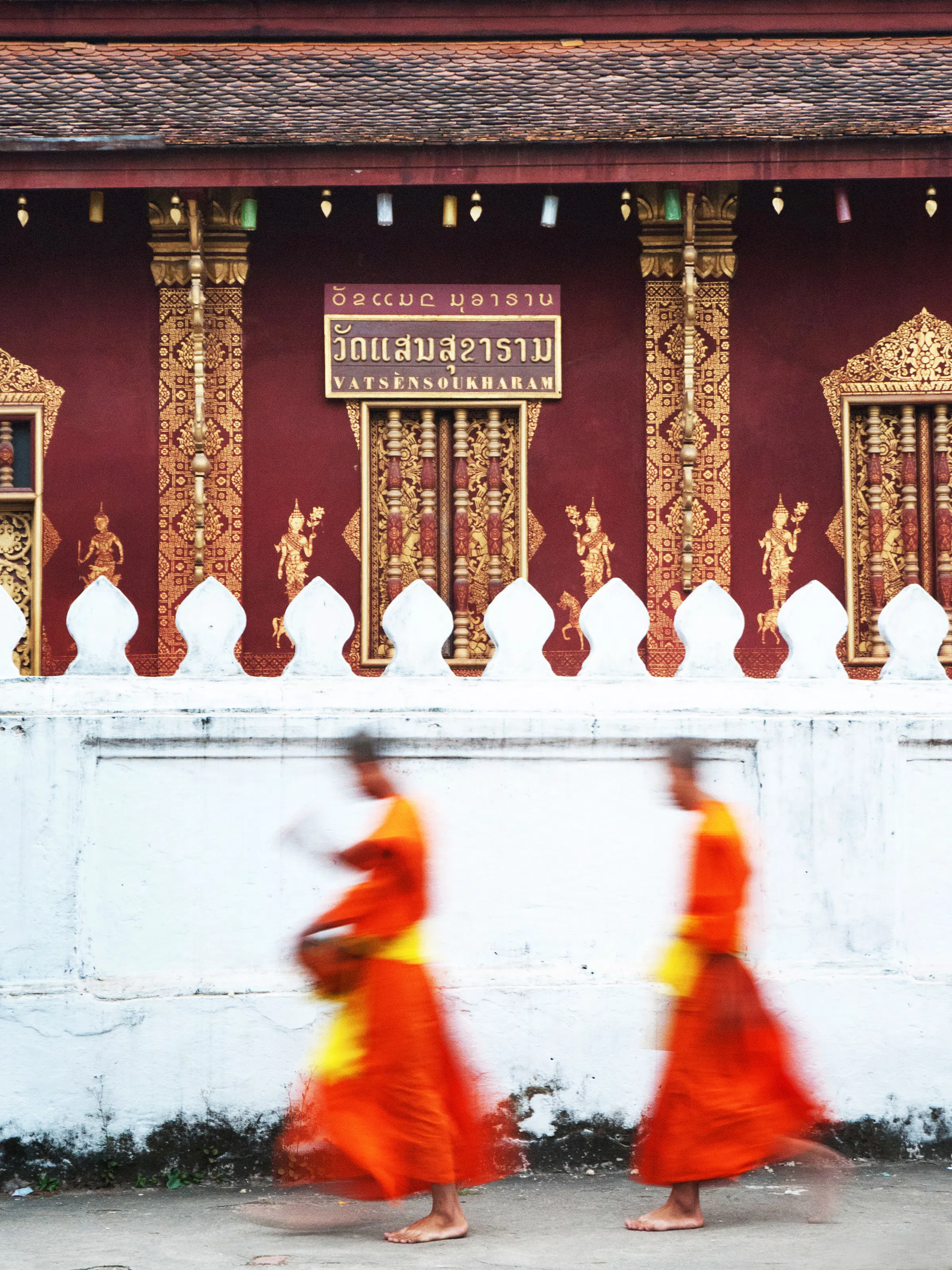 Buddhist monks in orange robes, Luang Prabang Laos temple