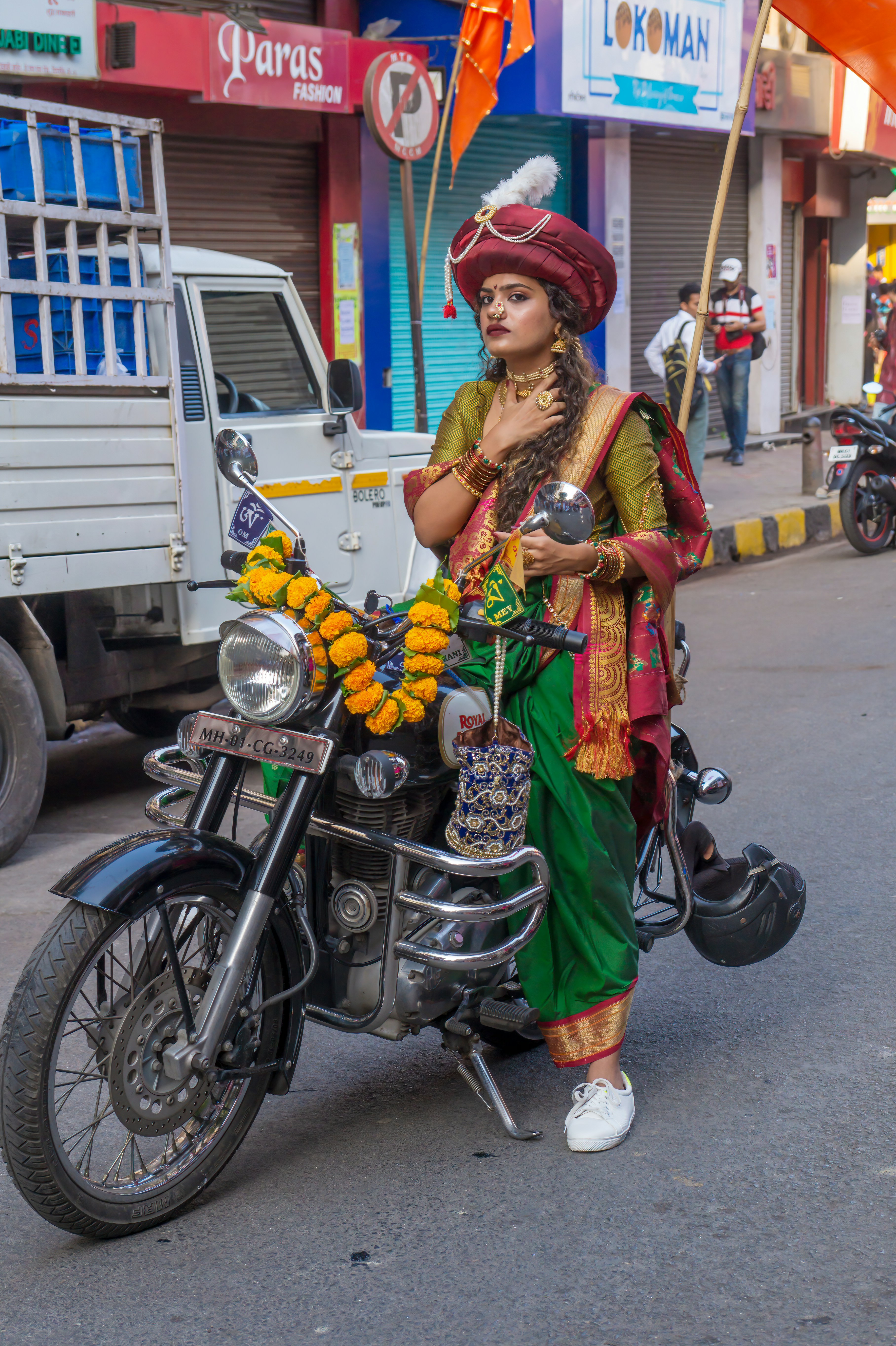 Woman in traditional Maharashtrian saree on motorcycle, Mumbai festival