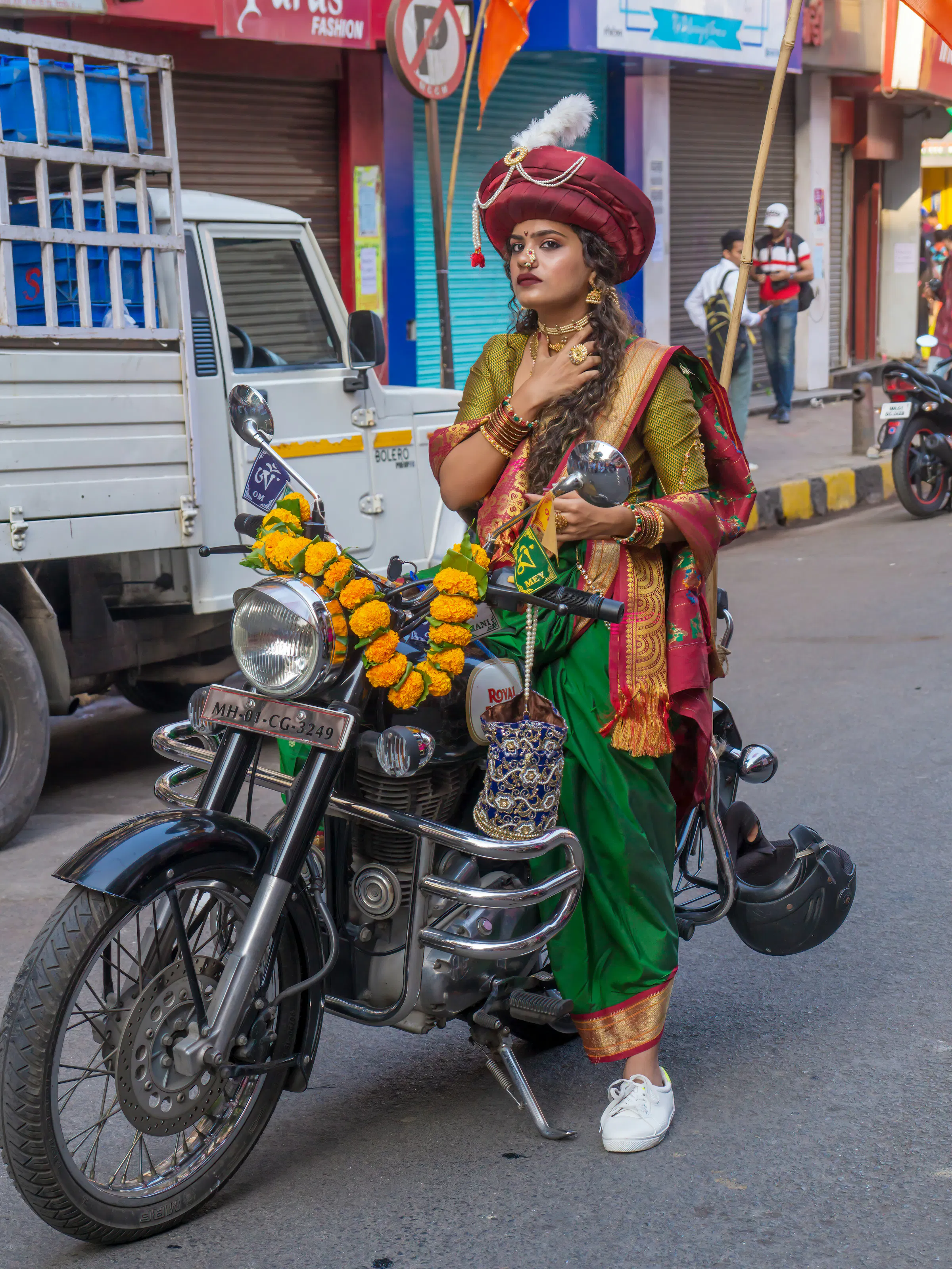 Woman in traditional Maharashtrian saree on motorcycle, Mumbai festival