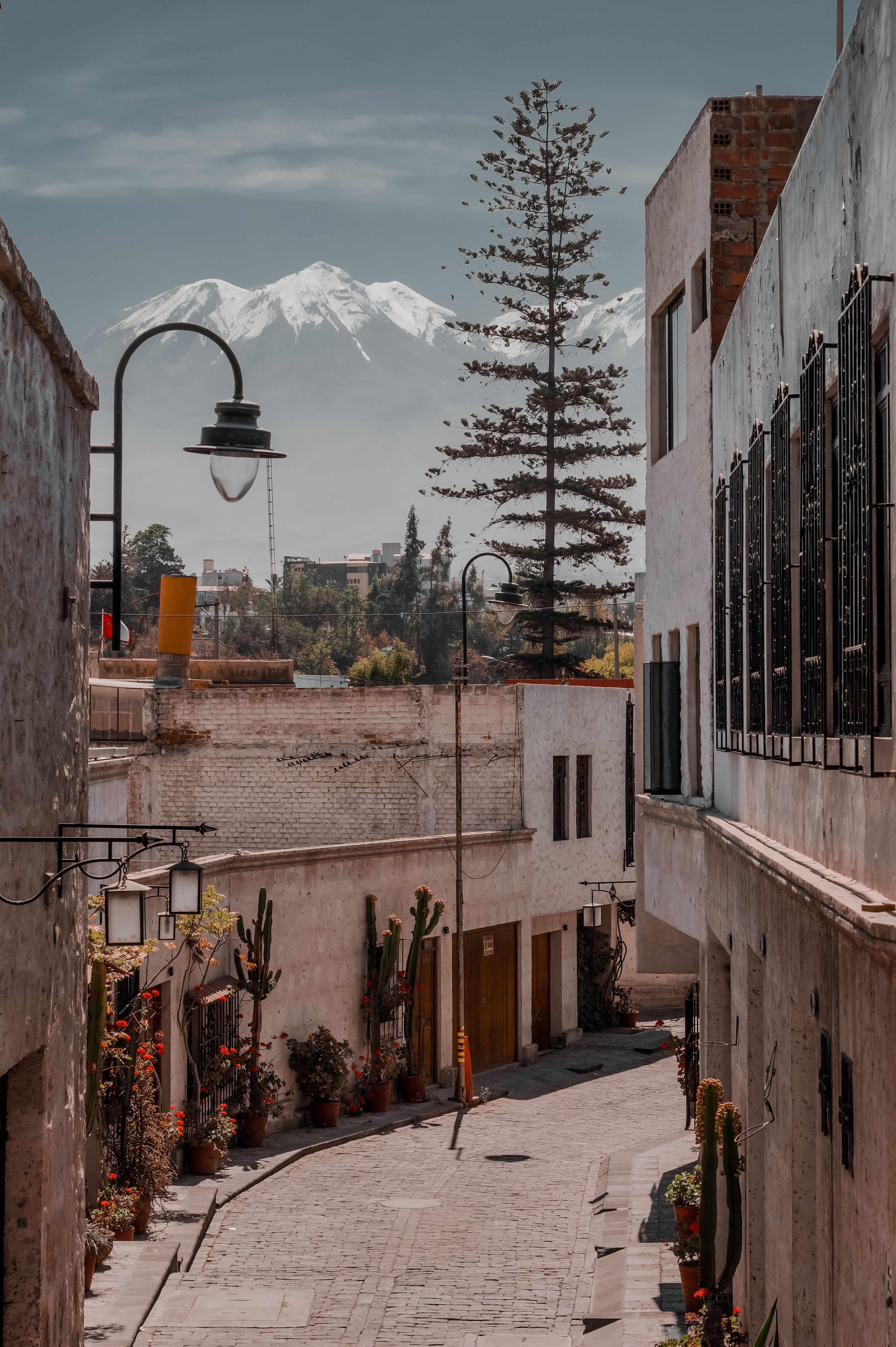 Cobblestone alley with snow-capped Chachani volcano, Arequipa Peru