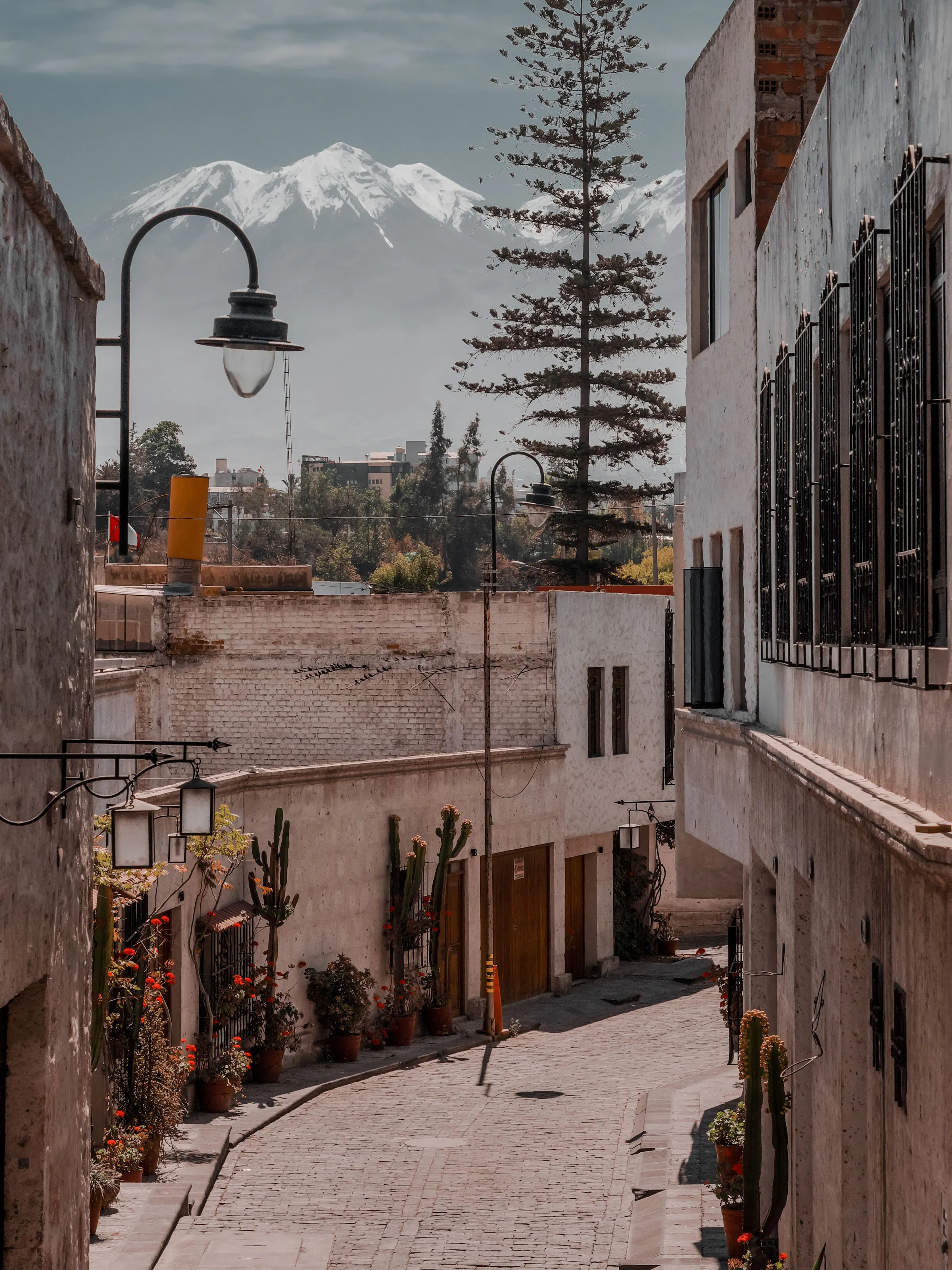 Cobblestone alley with snow-capped Chachani volcano, Arequipa Peru
