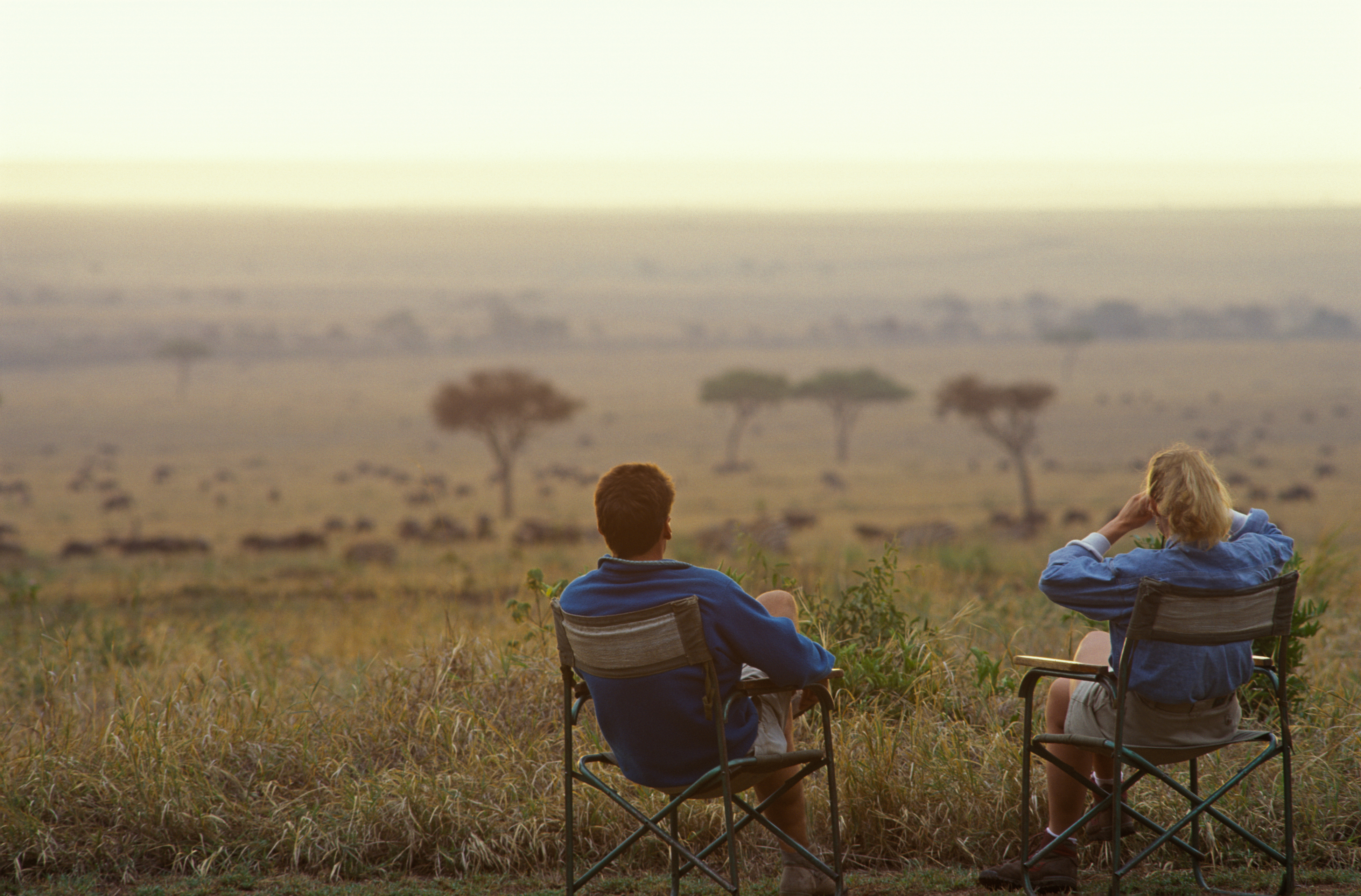 Safari-goers watching wildlife on the savanna in Meru National Park, Kenya