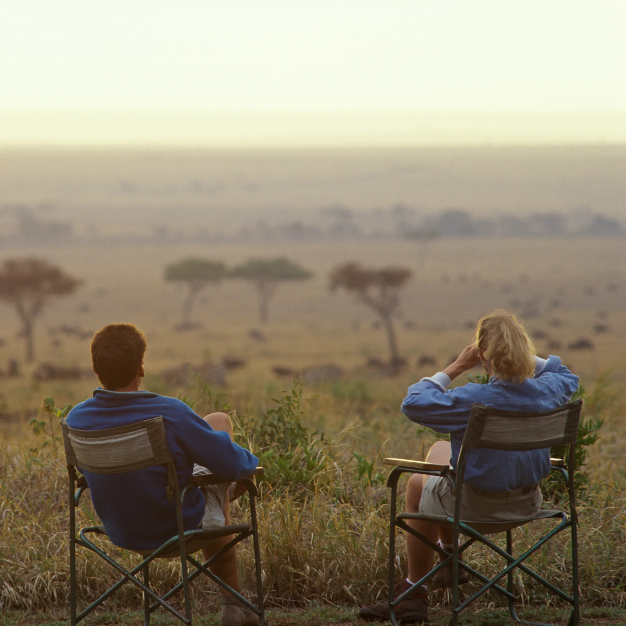 Safari-goers watching wildlife on the savanna in Meru National Park, Kenya