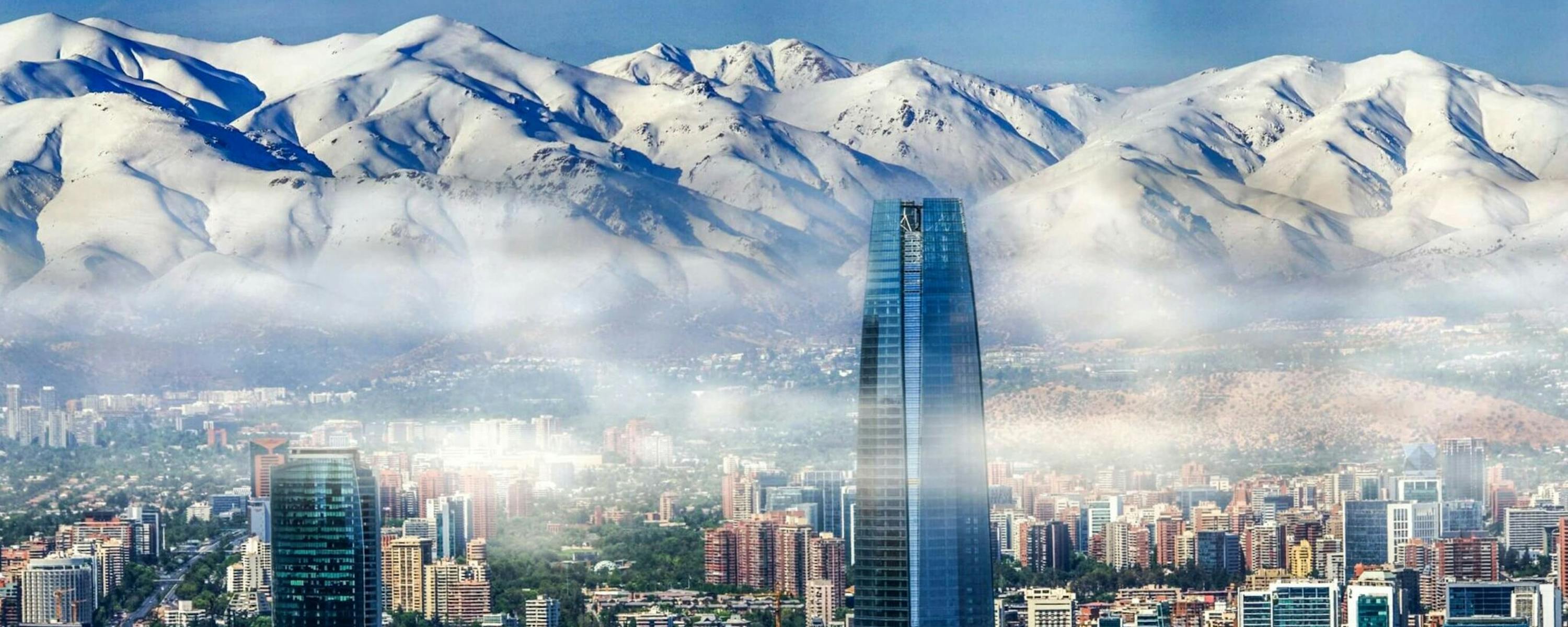 Santiago’s skyline stretches toward the Andes, with the tallest tower rising above the city under clear air.