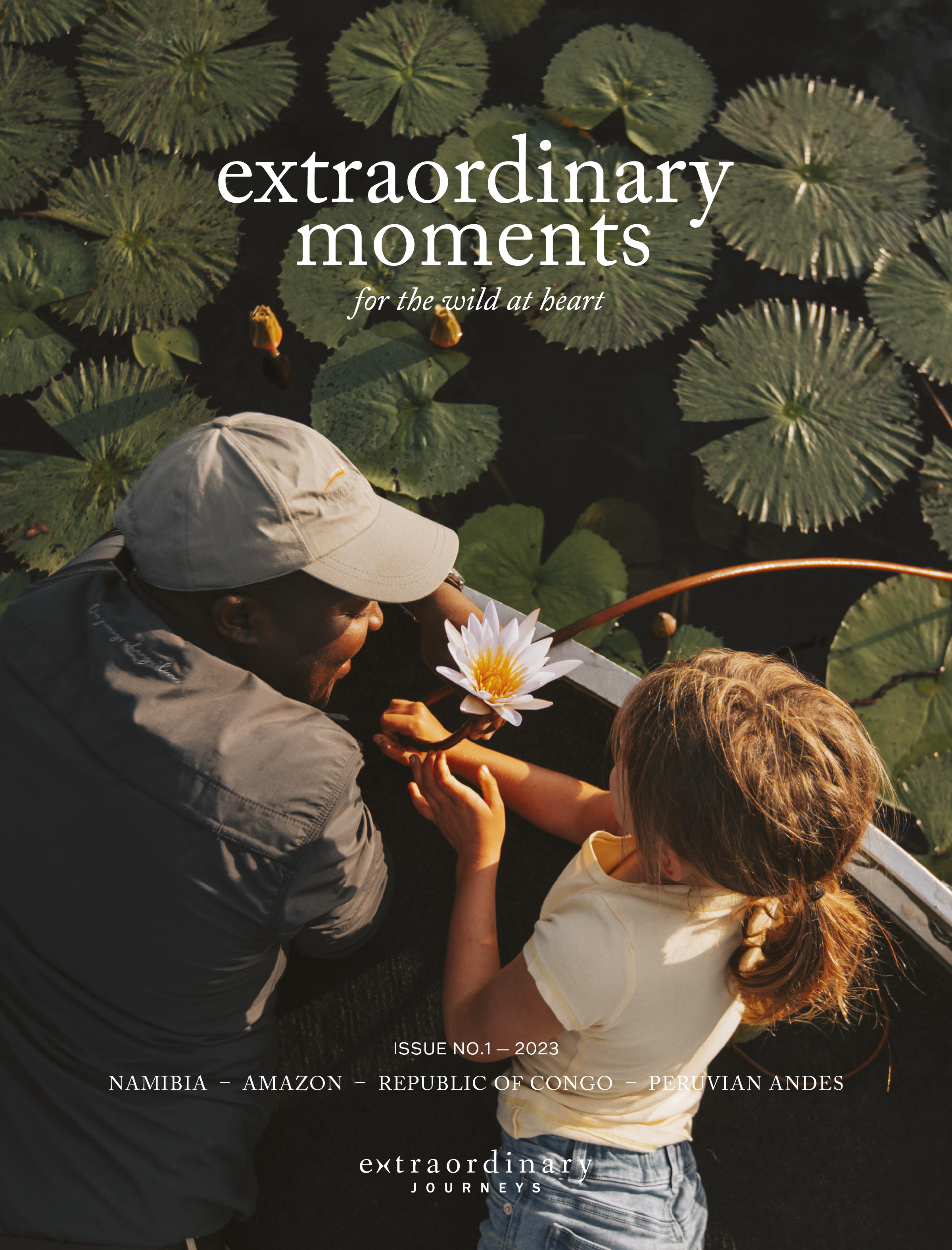 A herd of elephants stands in shallow water at golden hour. Cover text reads: “extraordinary moments – for the wild at heart.”