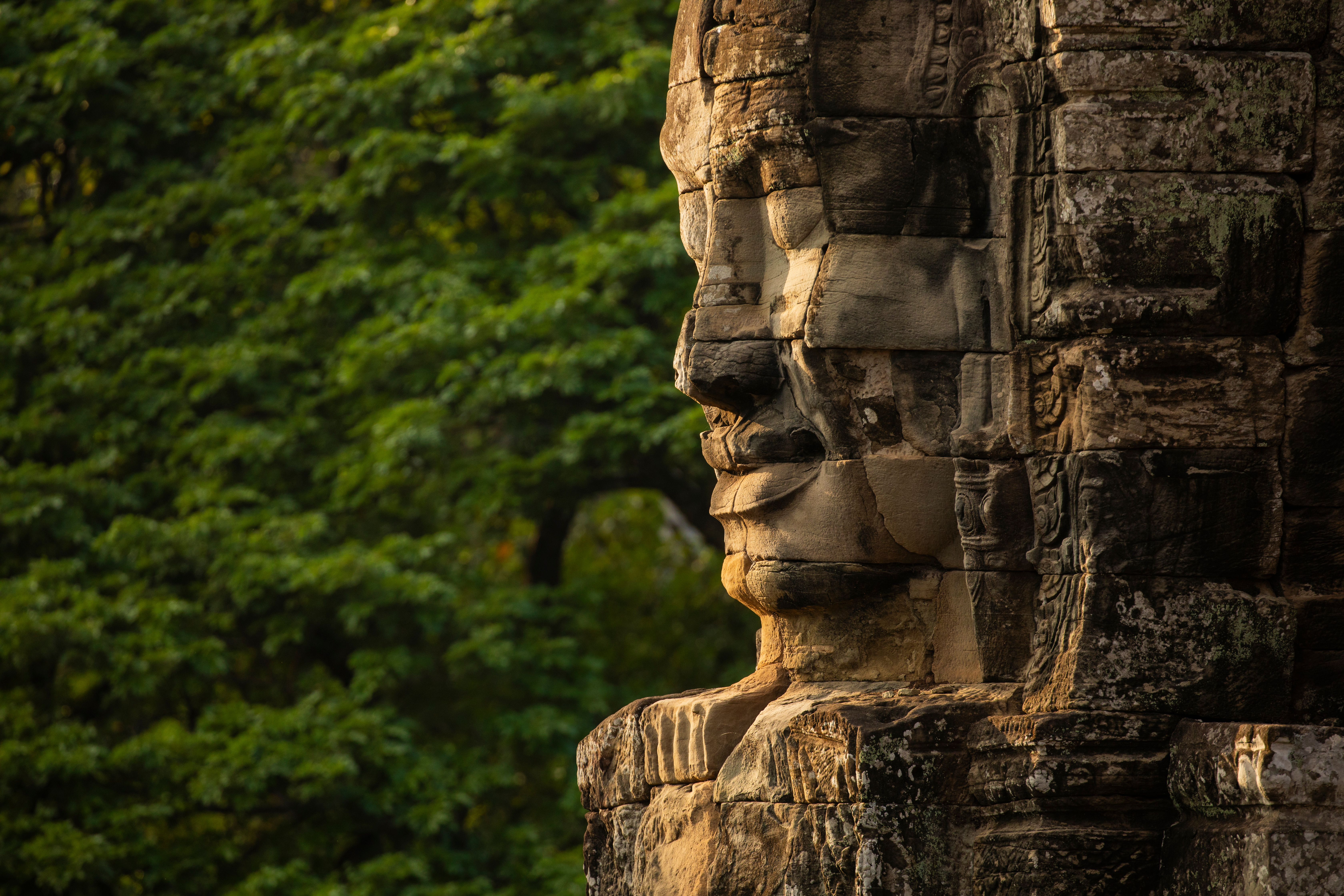 Giant stone face carved at Bayon Temple, Angkor Thom Cambodia