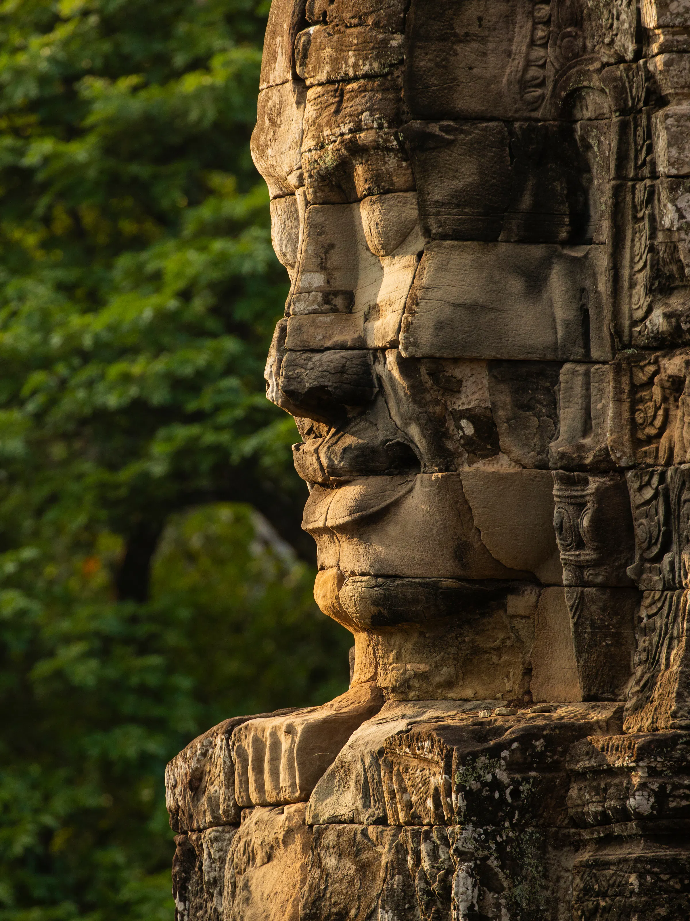 Giant stone face carved at Bayon Temple, Angkor Thom Cambodia