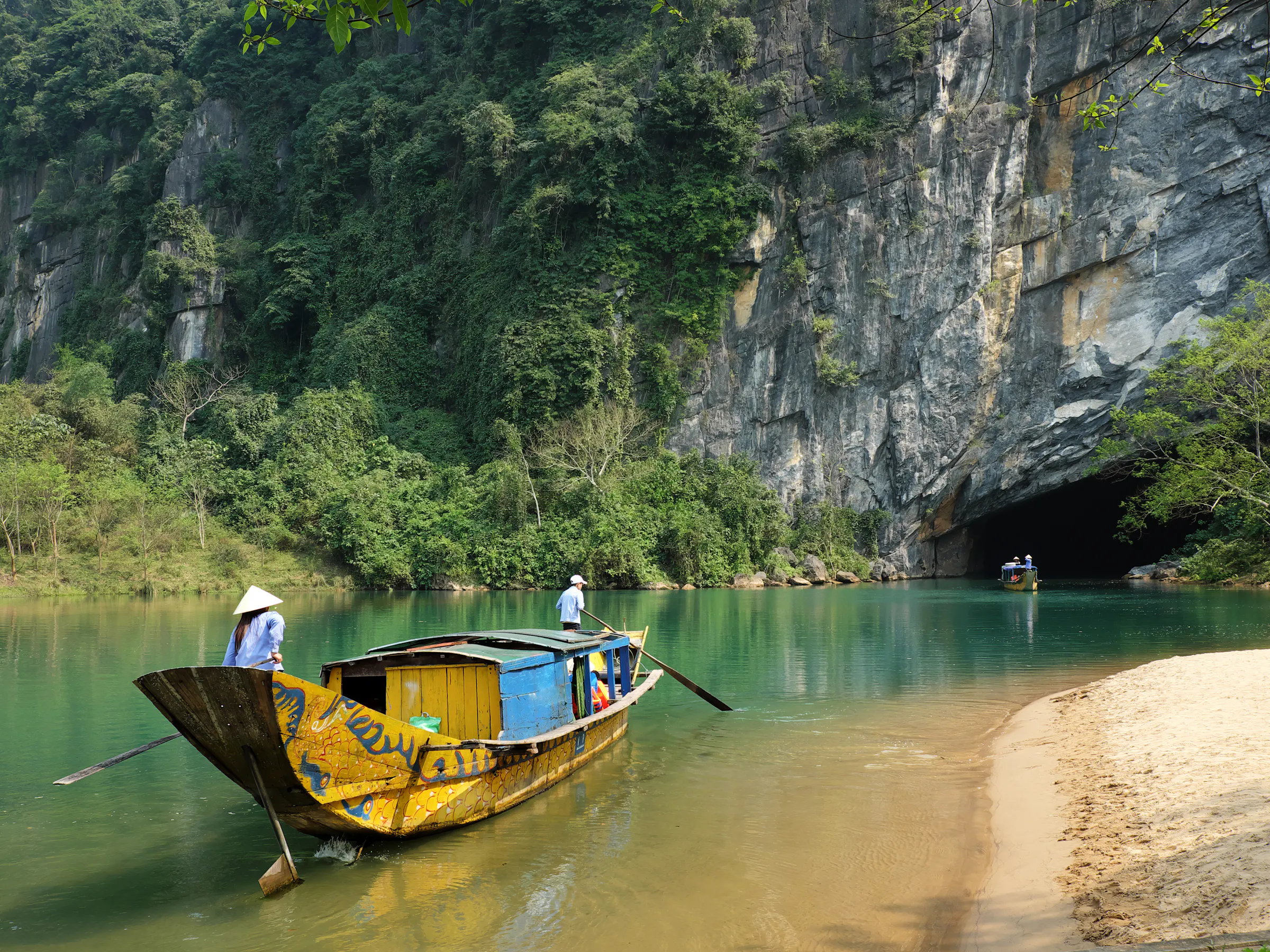 Traditional boat with tourists accessing Phong Nha cave