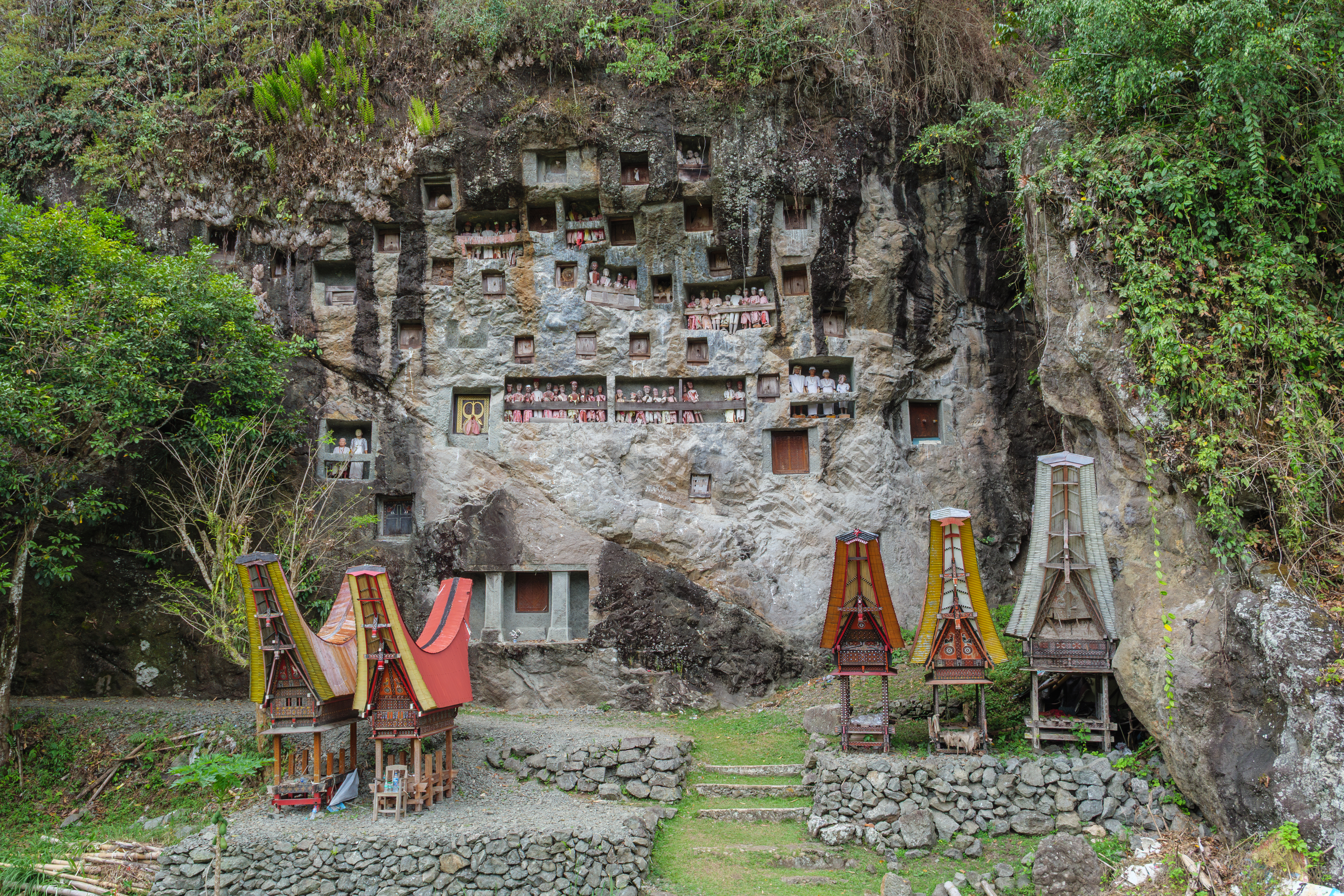 Traditional Toraja rock graves with tau tau gallery in a cliff face near Lemo.