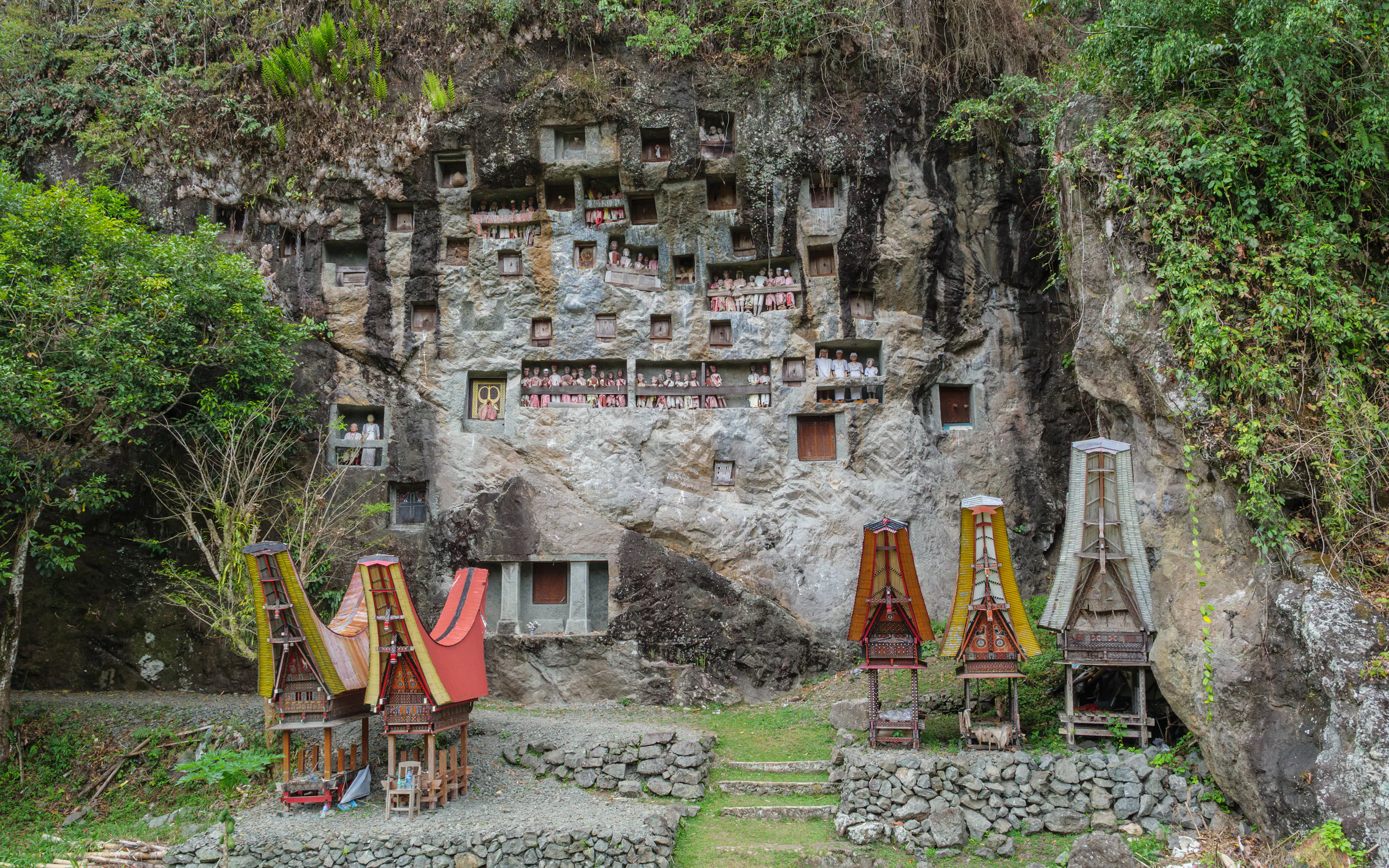Traditional Toraja rock graves with tau tau gallery in a cliff face near Lemo.