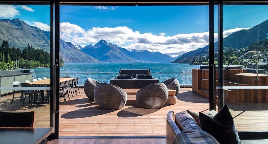 An elegant hotel lounge with lake and mountain views at Eichardt's Private Hotel in Queenstown, New Zealand.