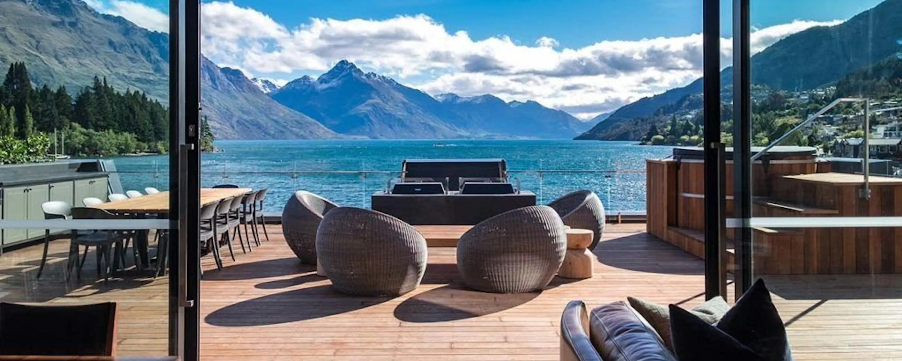An elegant hotel lounge with lake and mountain views at Eichardt's Private Hotel in Queenstown, New Zealand.