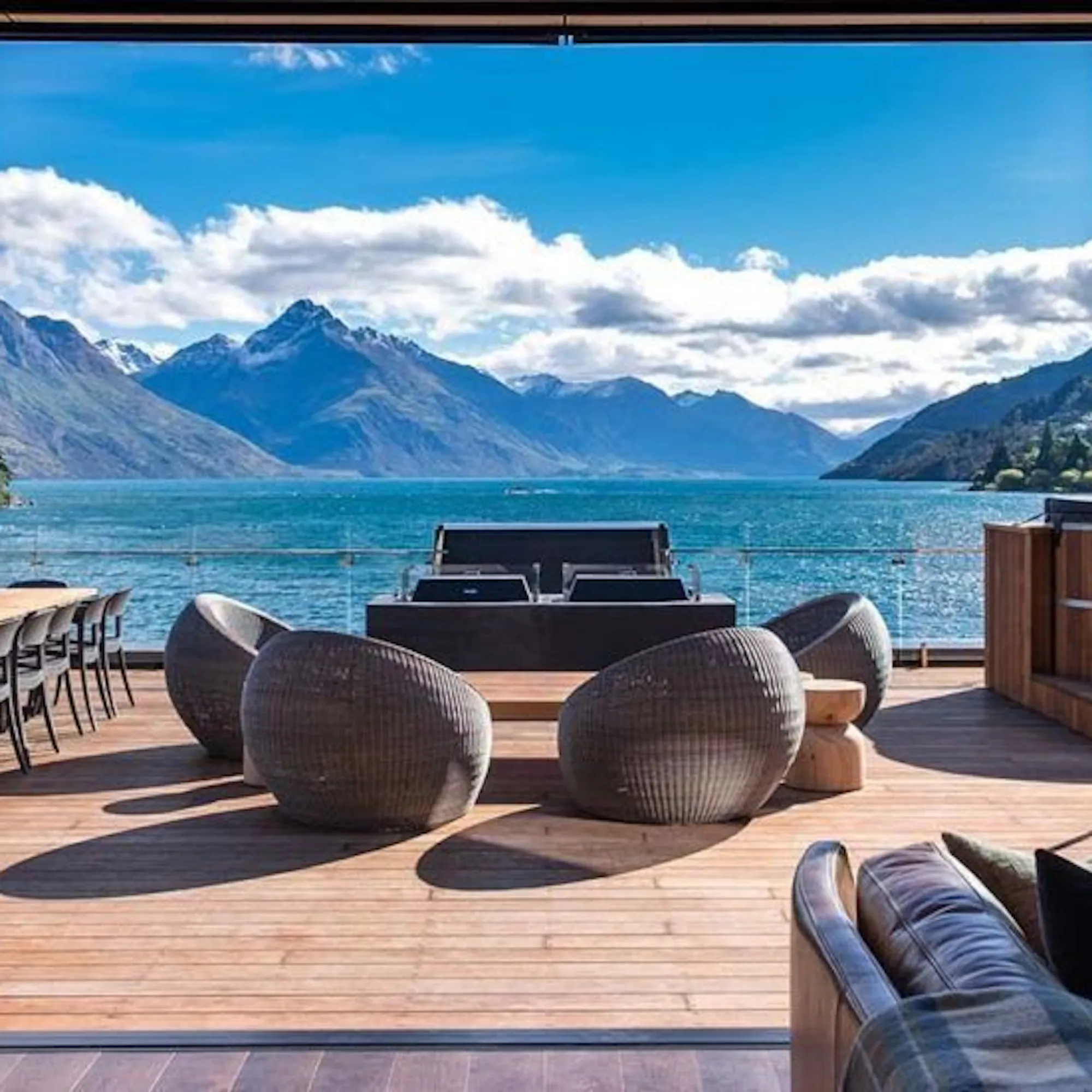 An elegant hotel lounge with lake and mountain views at Eichardt's Private Hotel in Queenstown, New Zealand.