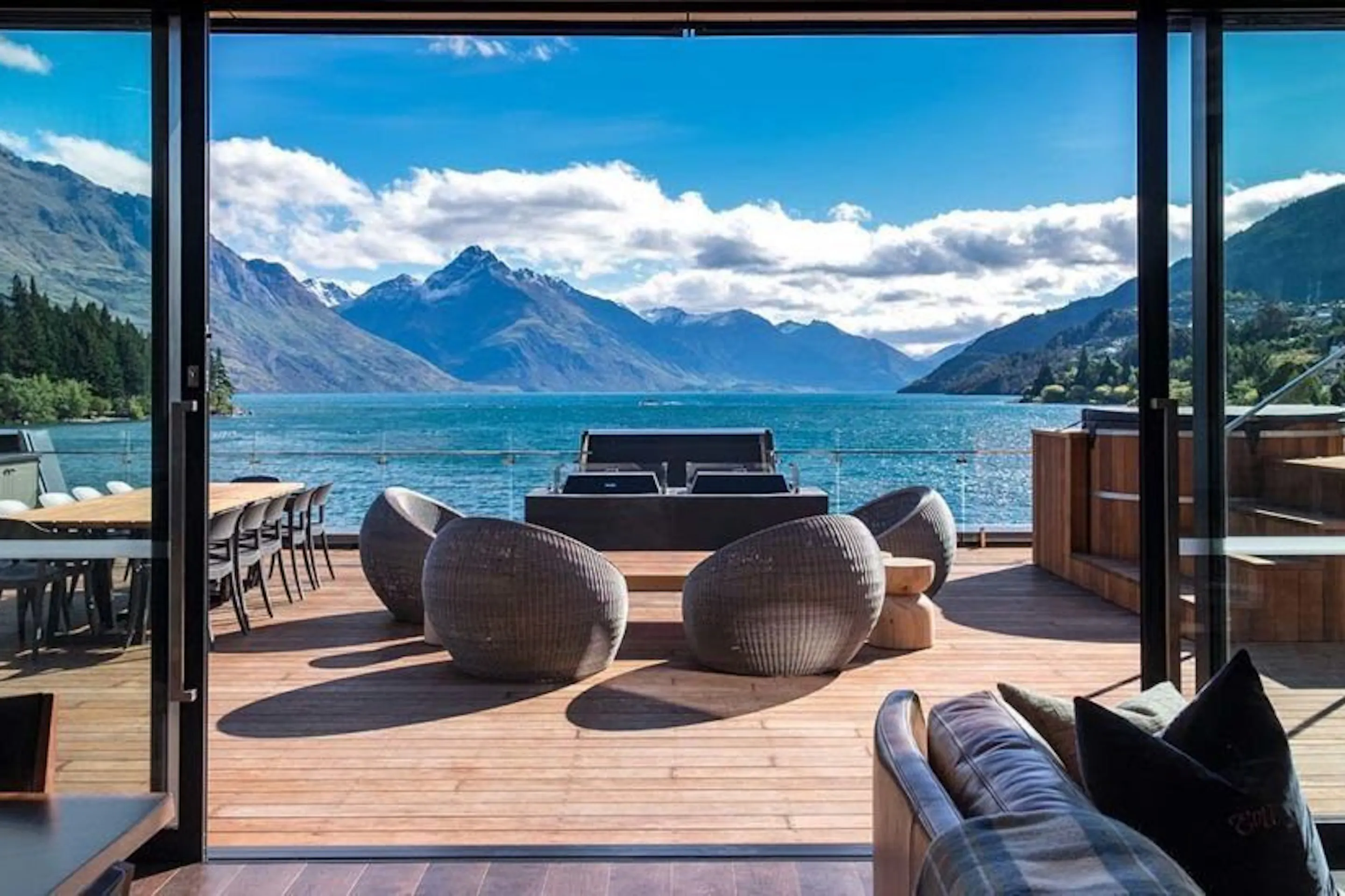 An elegant hotel lounge with lake and mountain views at Eichardt's Private Hotel in Queenstown, New Zealand.