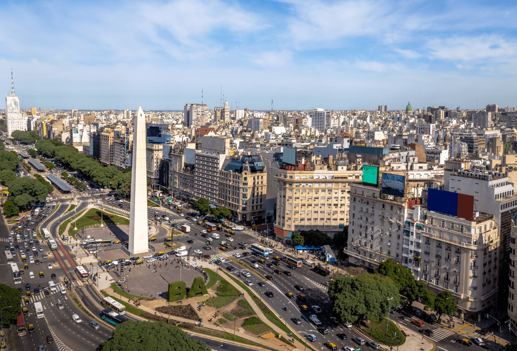 The Obelisk and broad lanes of 9 de Julio Avenue cut through central Buenos Aires beneath a clear morning sky.