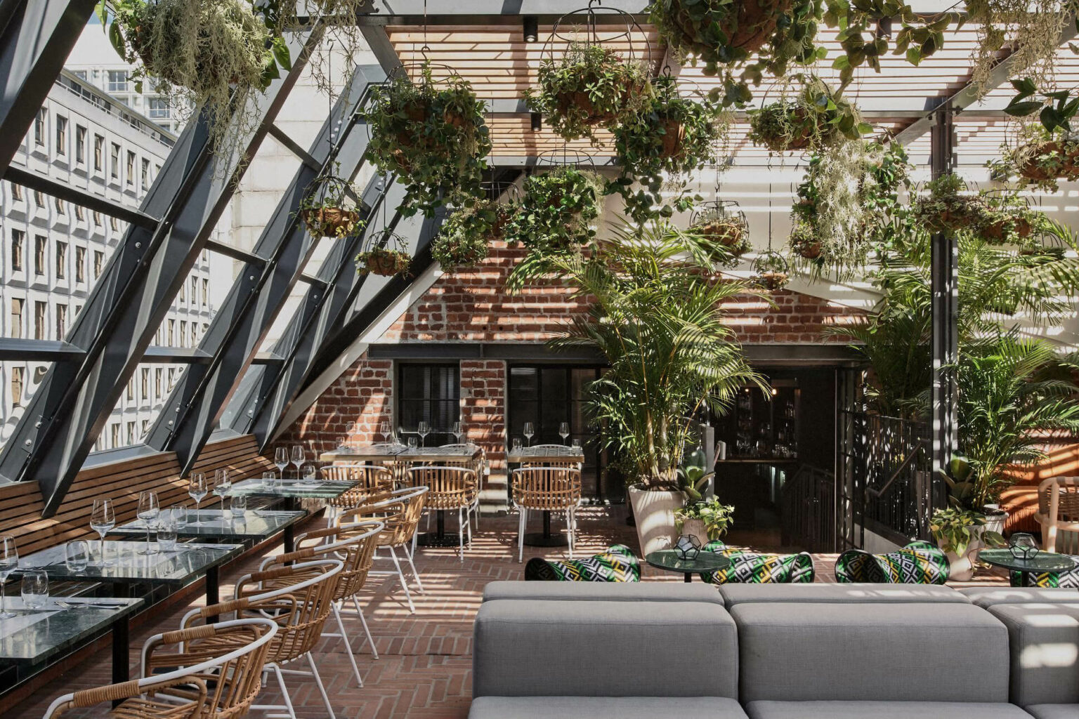 A lush rooftop lounge filled with plants and seating at Gigi Rooftop in Cape Town.