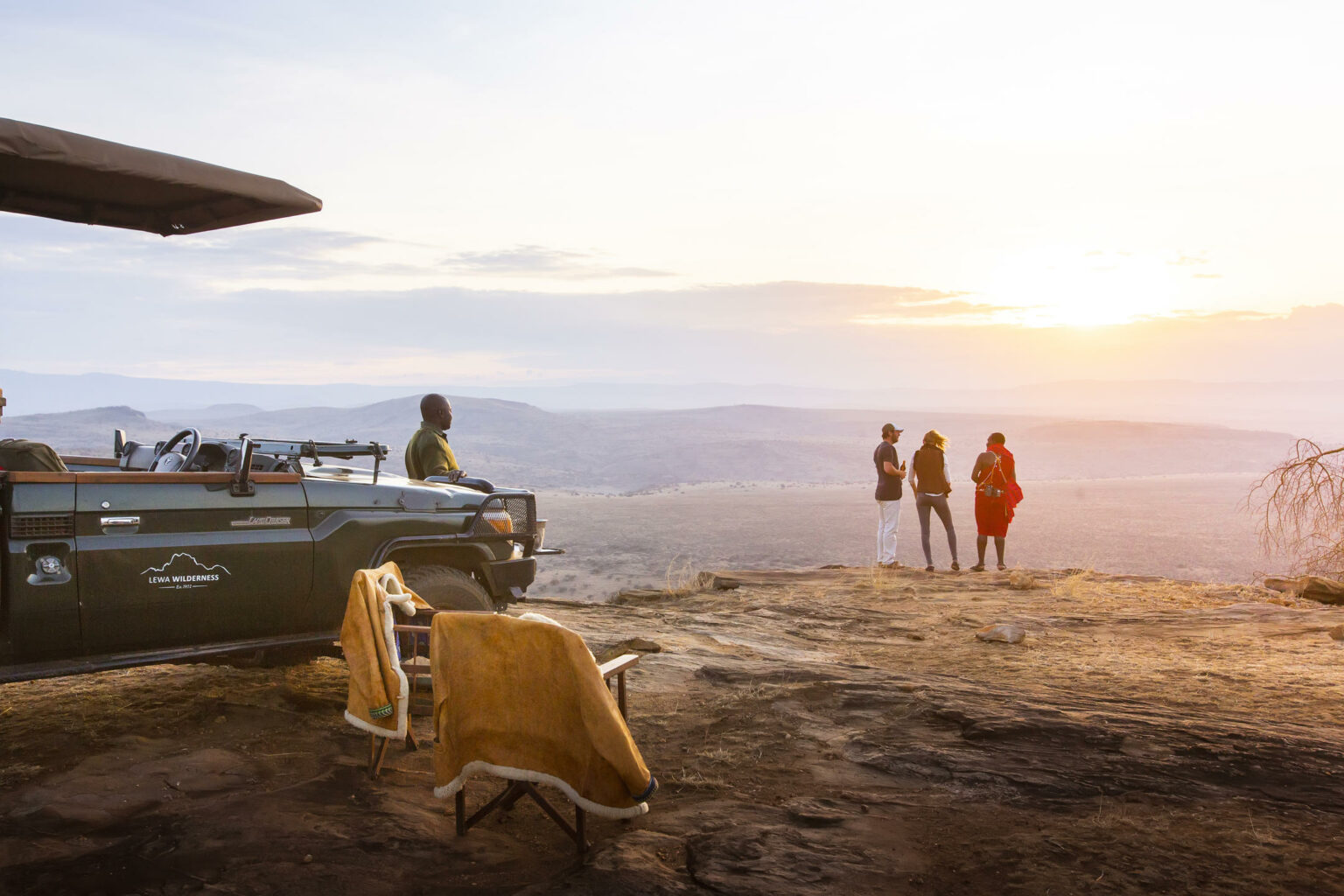 Open plains stretch toward Mount Kenya in Laikipia, with dry grassland and distant hills beneath a bright sky.